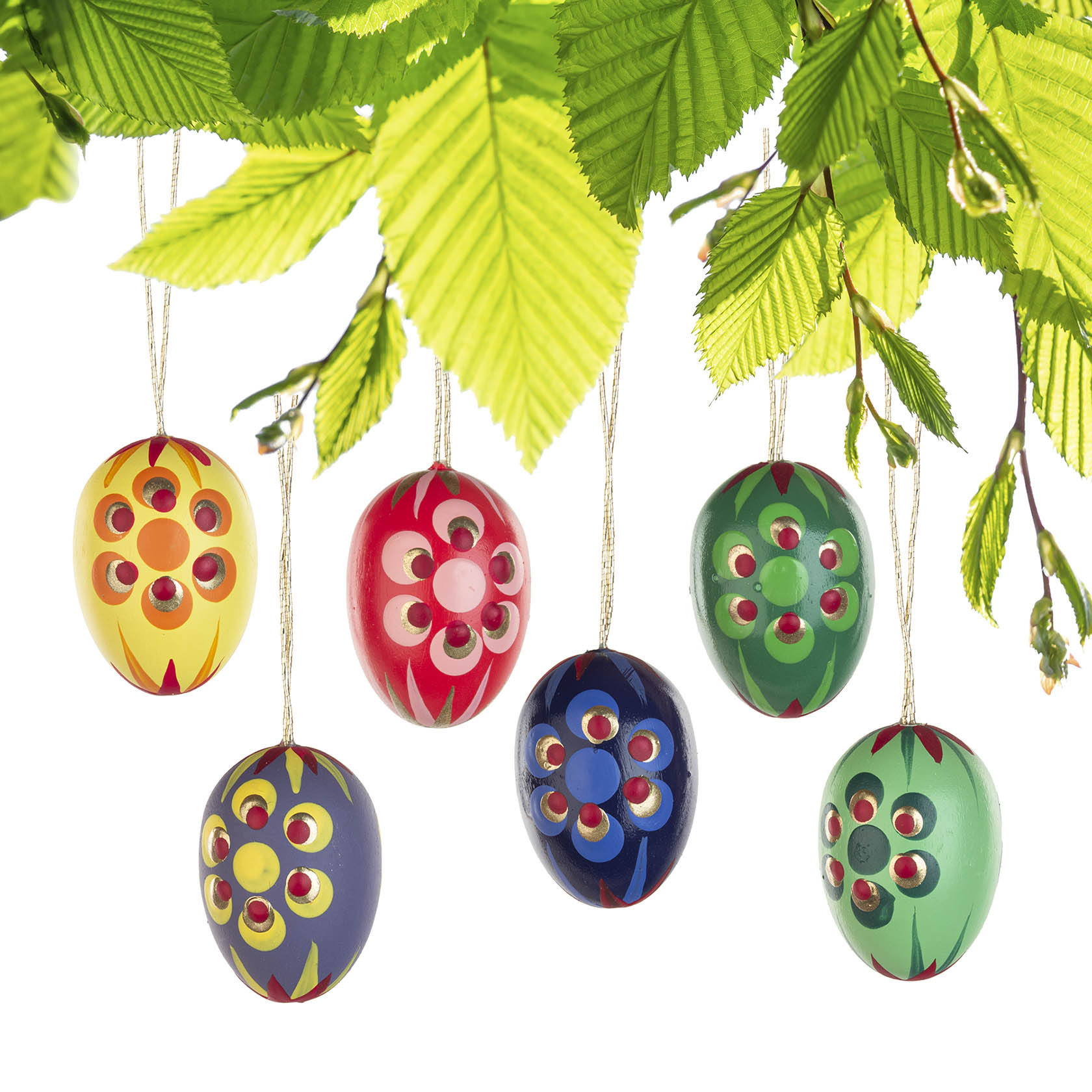 Six colorful, hand-painted Easter eggs hanging from a branch with green leaves. Each egg has a floral pattern in different colors.