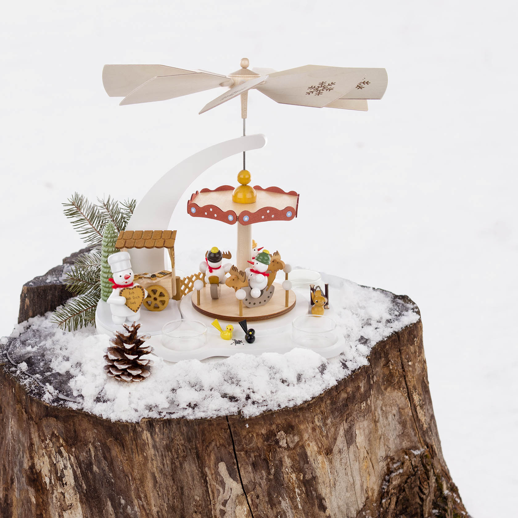 A white 'snowman carousel' pyramid featuring wooden snowmen figures on a rotating platform, with space for tealights underneath, designed for exclusive decor.