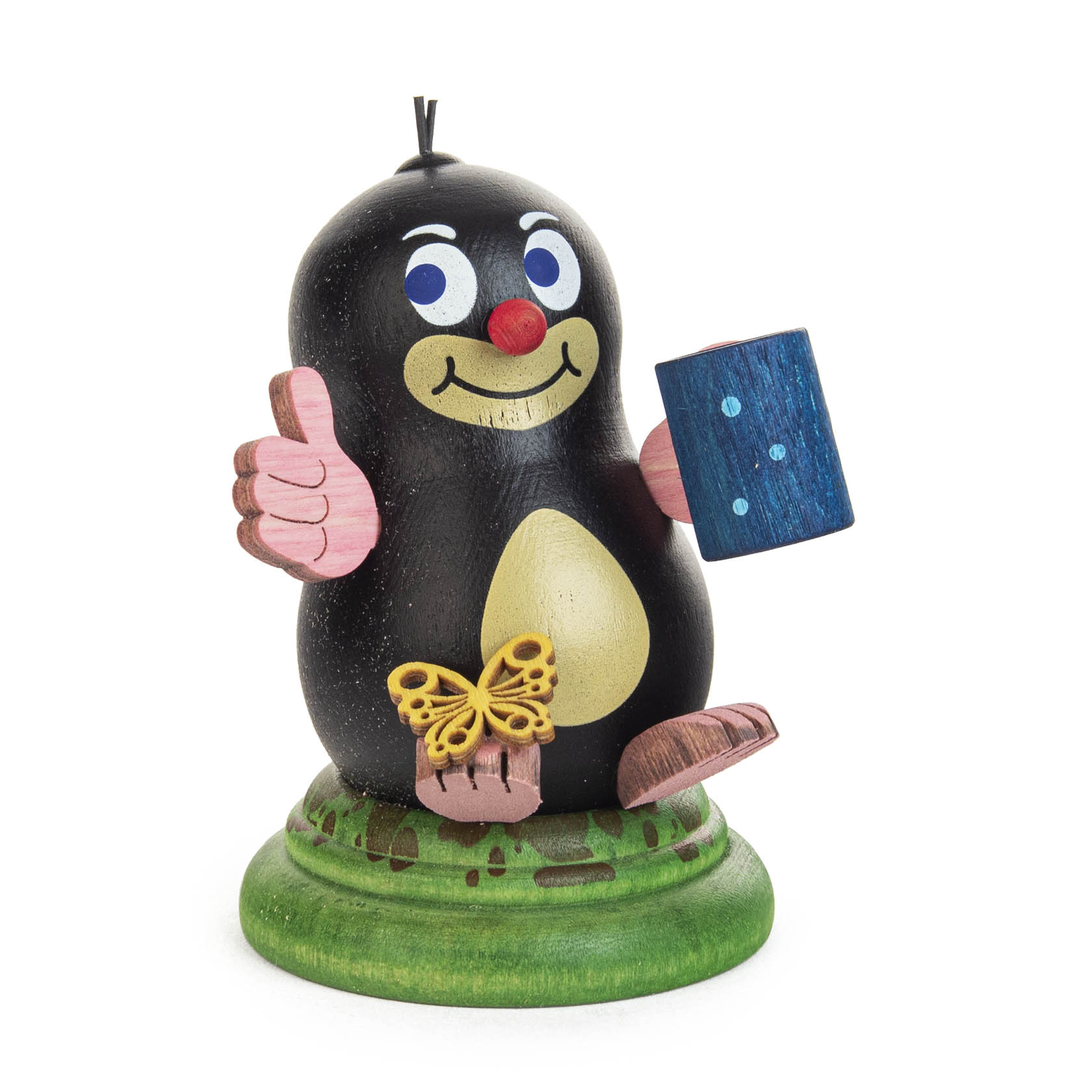 Holzfigur eines lächelnden Maulwurfs mit Daumen hoch, Schmetterling auf dem Fuß und einem blauen Buch in der Hand. im Dregeno Online Shop günstig kaufen