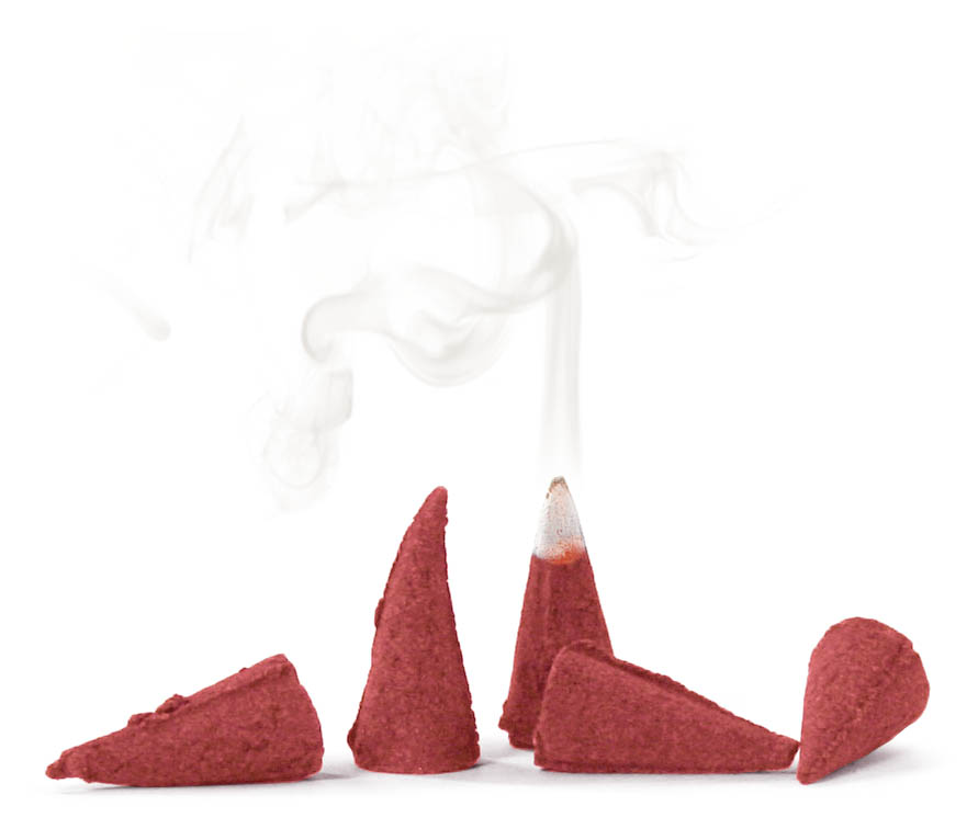 Five red, cone-shaped incense burners, one emitting smoke from the tip.