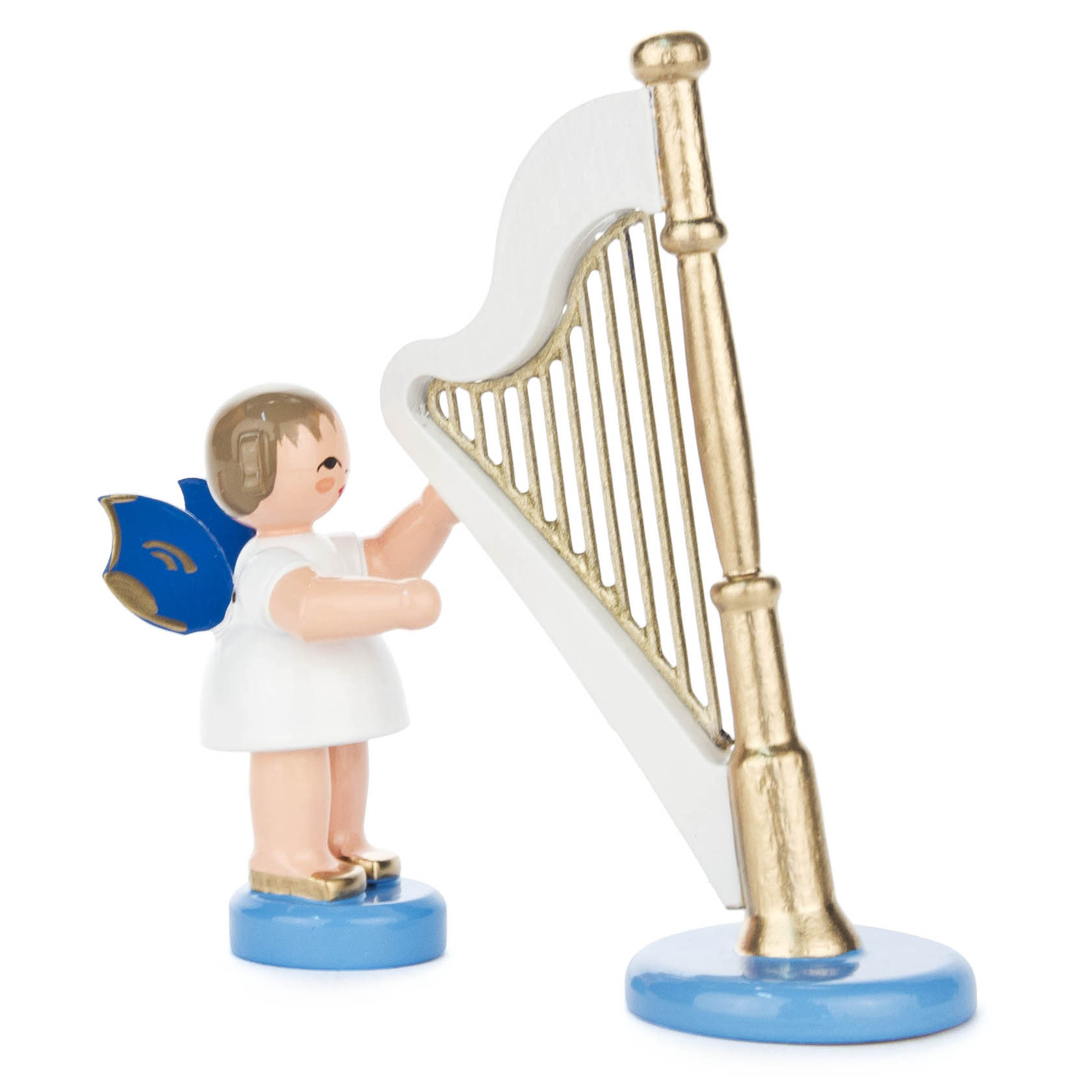 A small angel figure with a white dress and blue wings stands playing a tall golden harp.