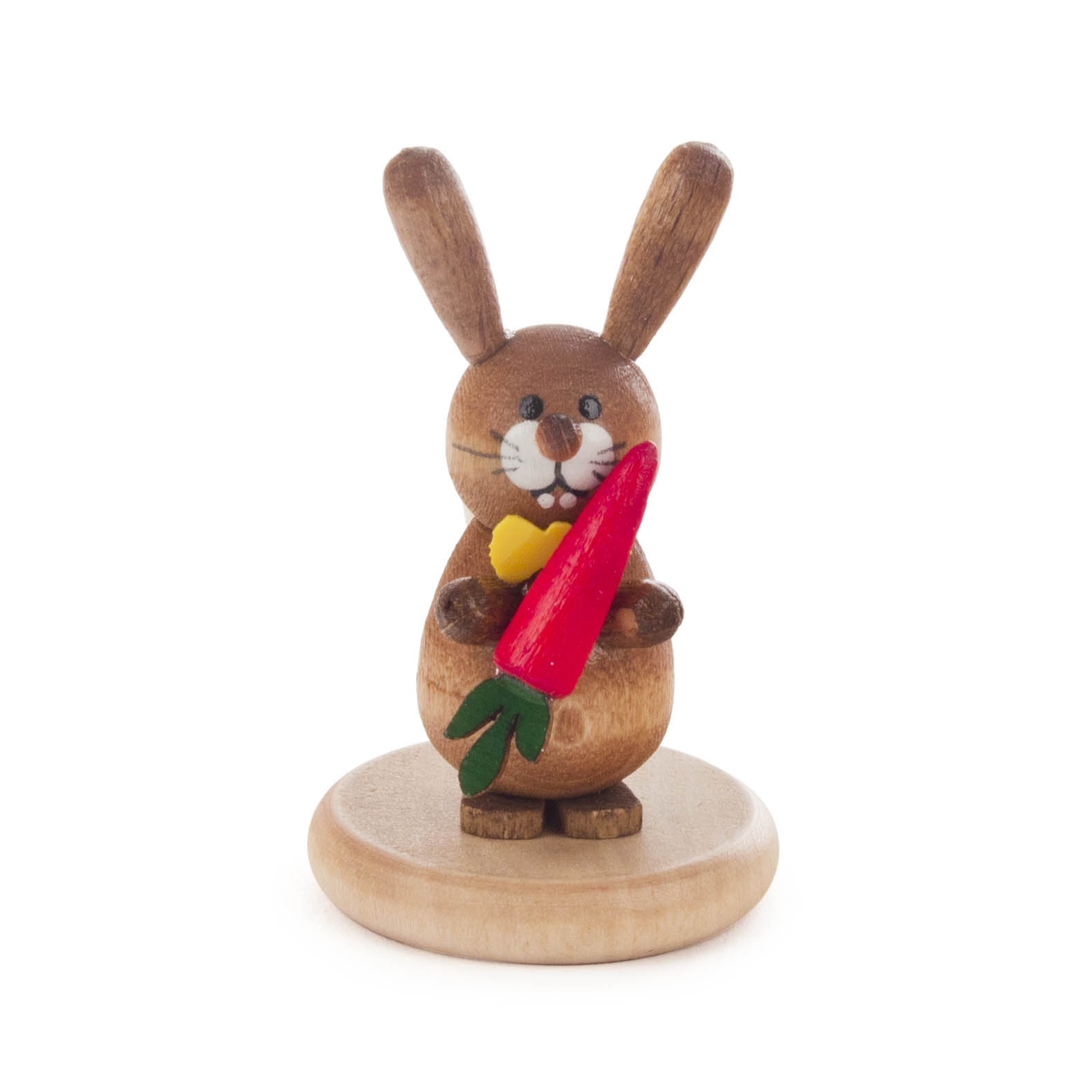 A colorful, glazed wooden rabbit figurine holding a carrot, standing on a round wooden base.