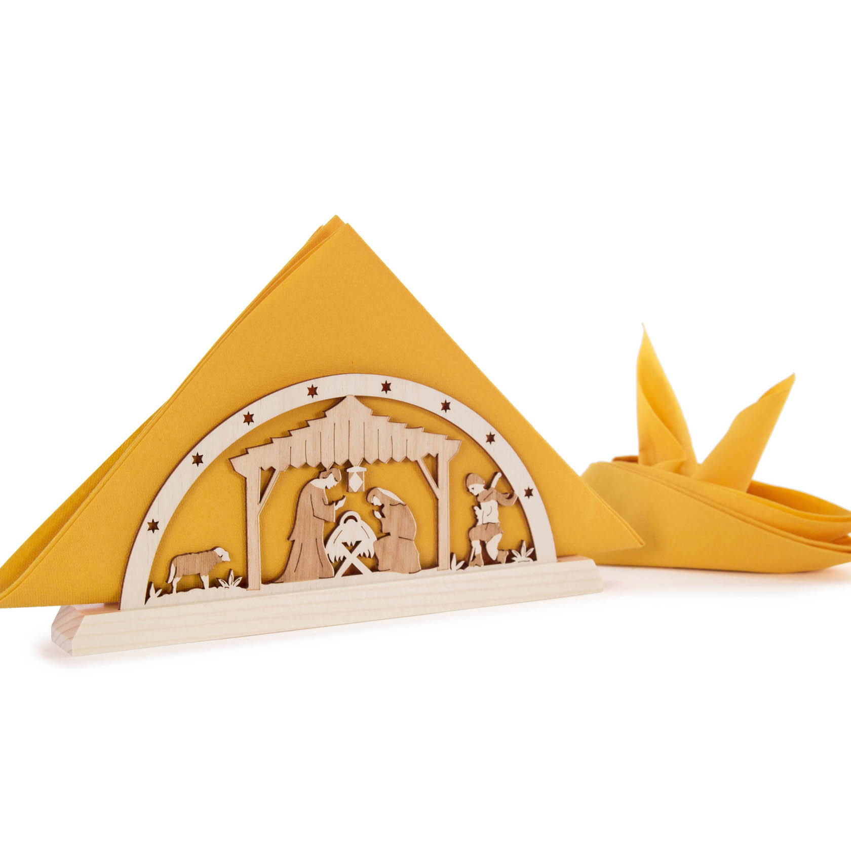 Holz-Serviettenhalter mit ausgeschnittener Szene der Geburt Christi, gelbe Servietten sind darin gefaltet.