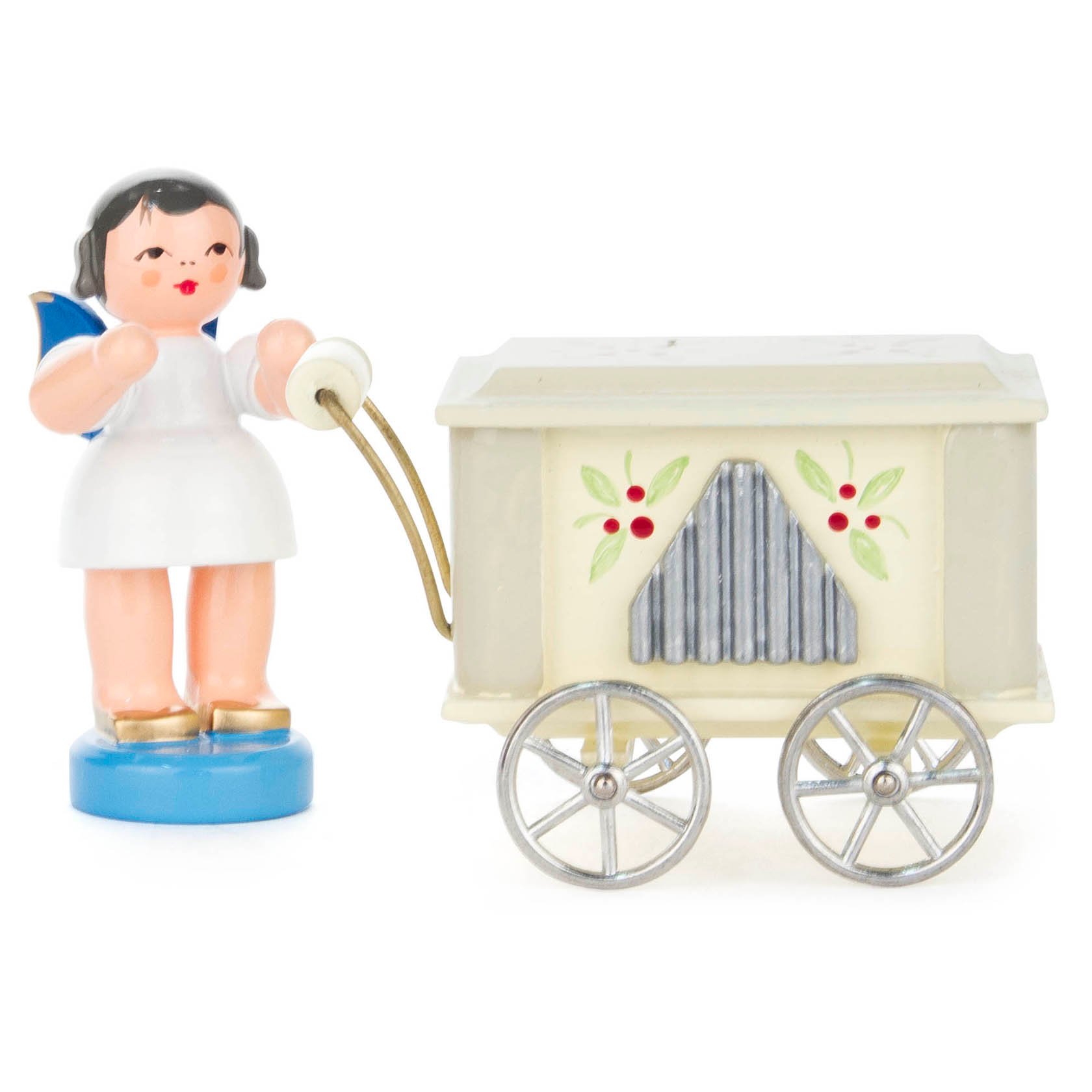 A small figurine of an angel with blue wings standing beside a vintage-style barrel organ. The angel is holding the organ's handle.