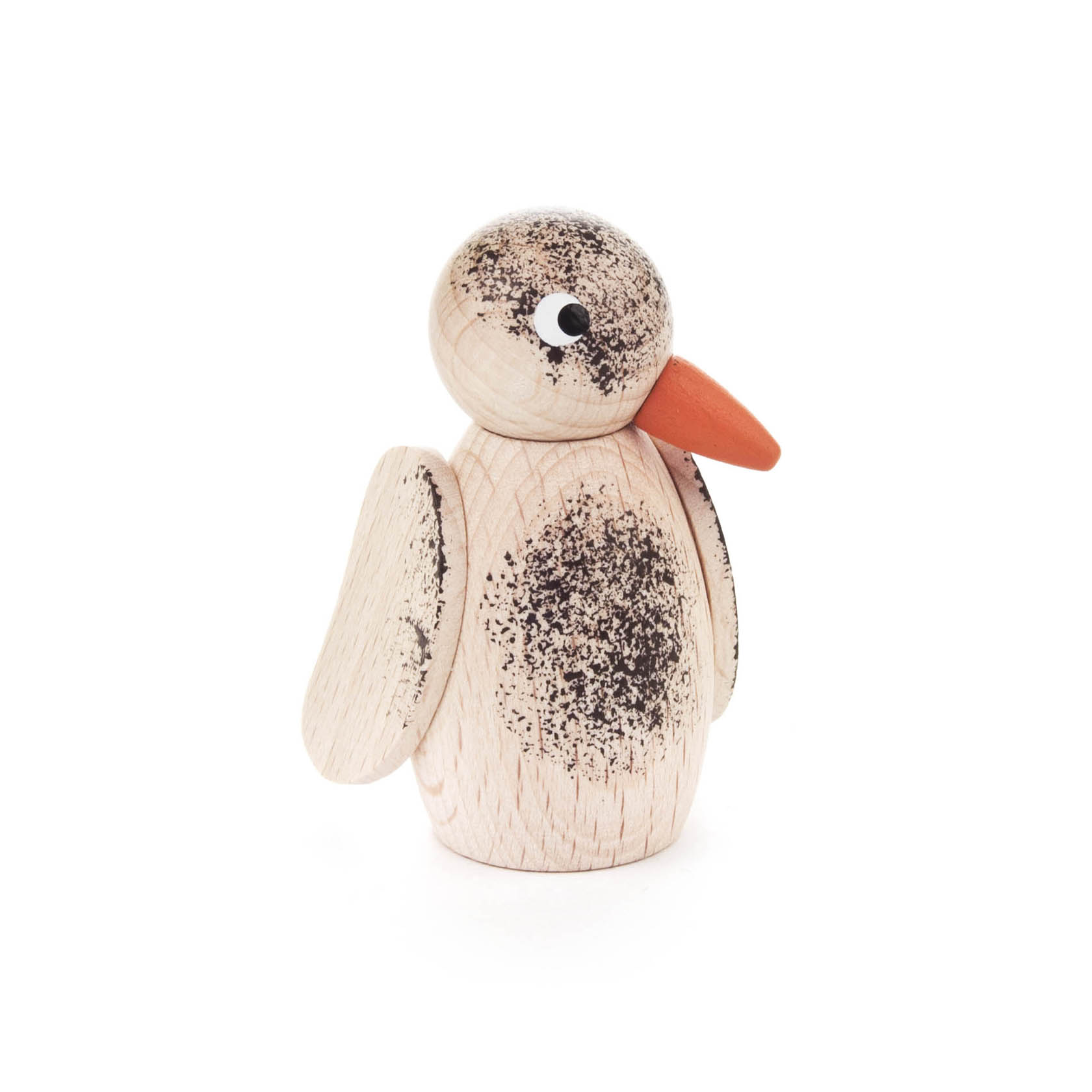 A wooden bird figure with a large orange beak and spotted head, giving a whimsical expression.