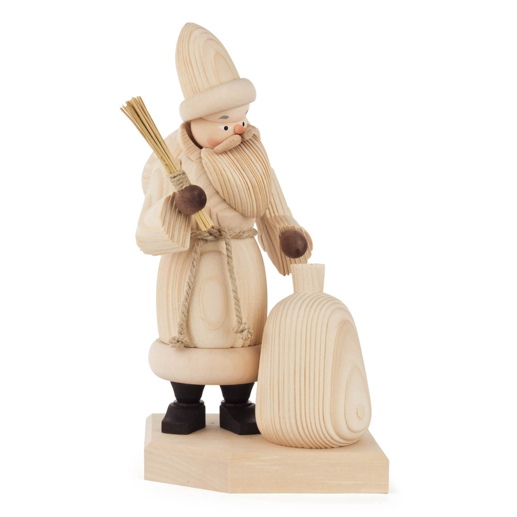Natural wooden figurine of a smoking Santa Claus, holding a sack and a small broom with a textured surface, standing on a base.
