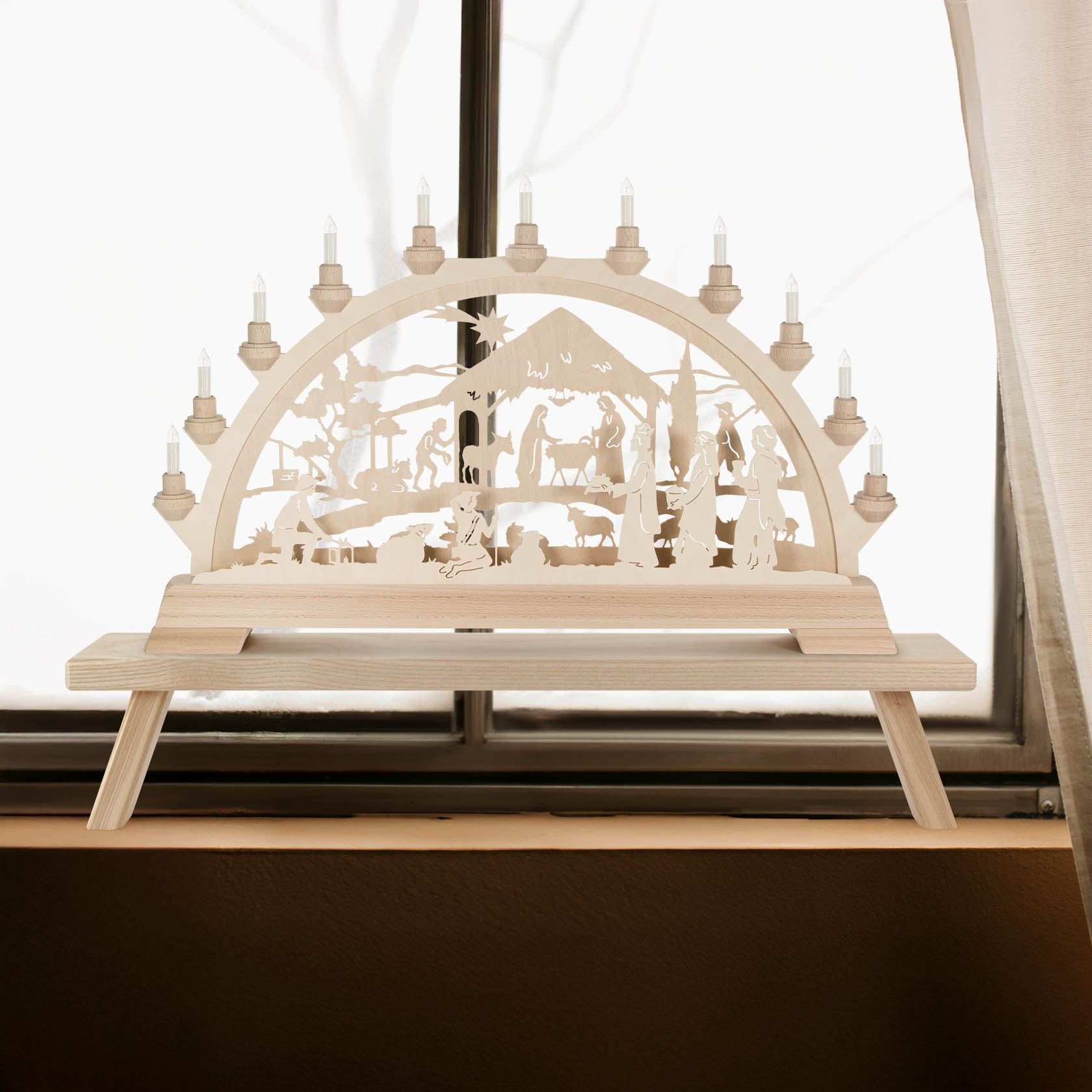 Electric illuminated Schwibbogen depicting the Nativity scene with figures of Mary, Joseph, and baby Jesus under a manger.