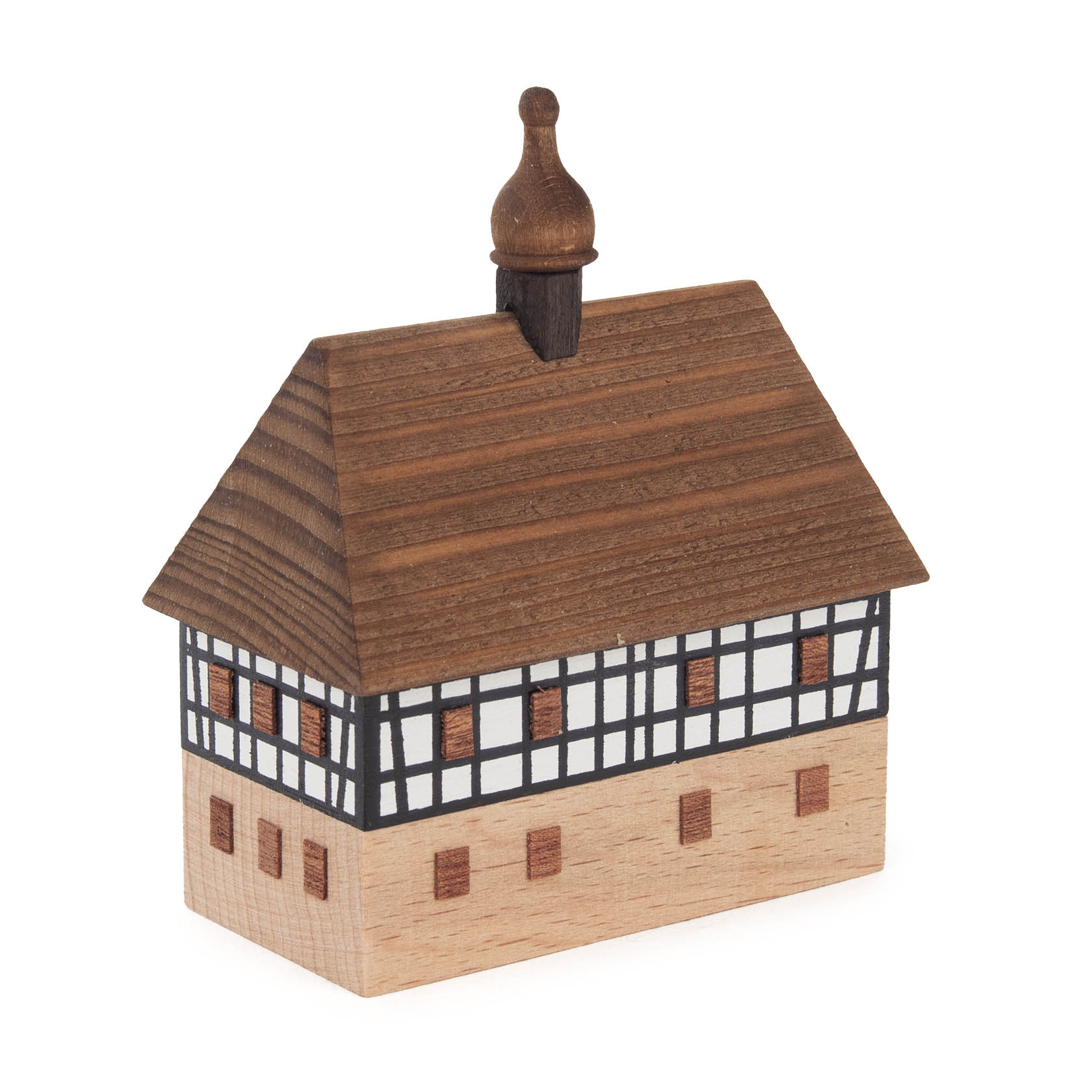 Wooden model of a two-story village school with a timber-framed upper level and a tiled roof, featuring a small bell tower.