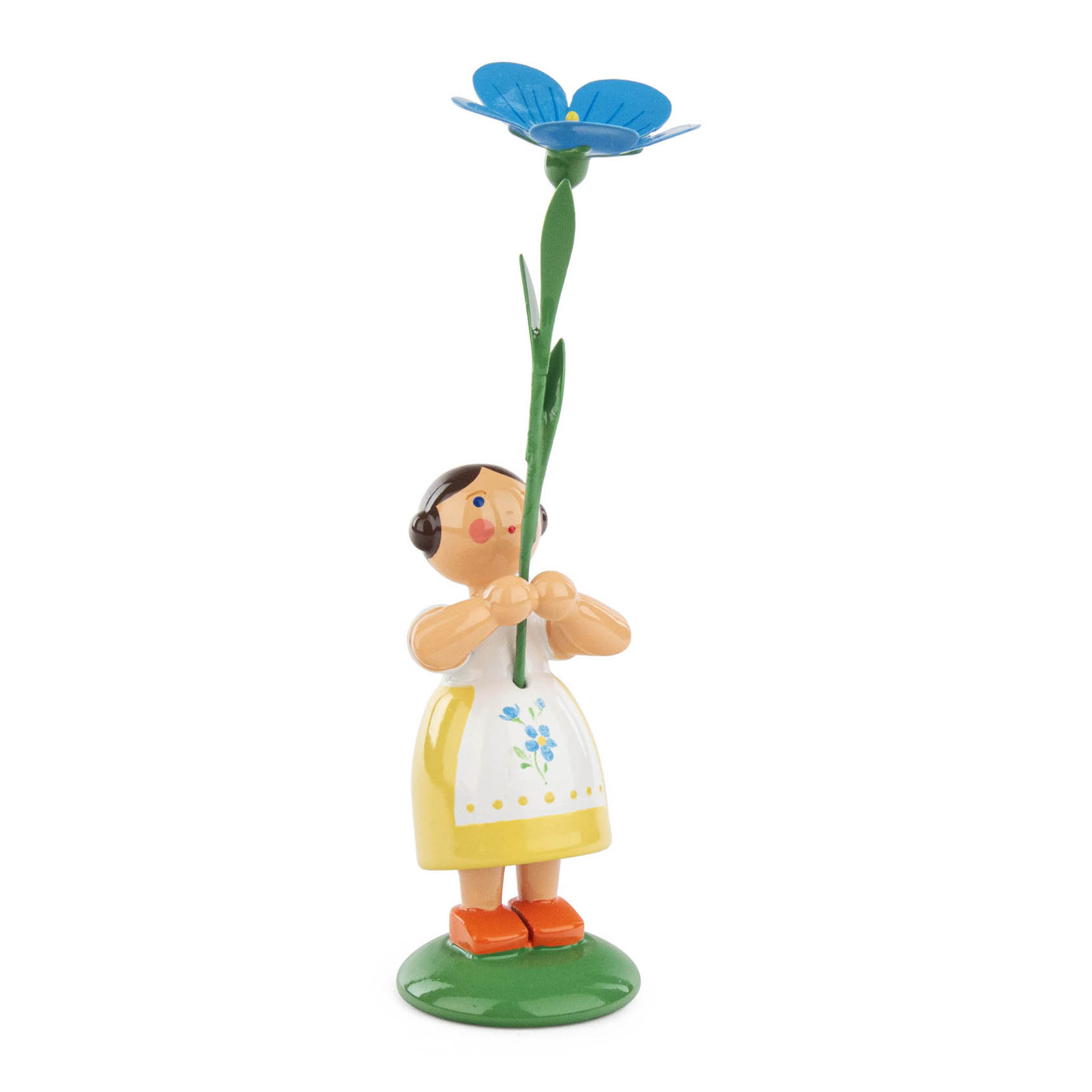 A handmade wooden figurine of a flower girl holding a tall bright blue flax flower. She wears a yellow dress with a floral pattern and orange shoes. im Dregeno Online Shop günstig kaufen