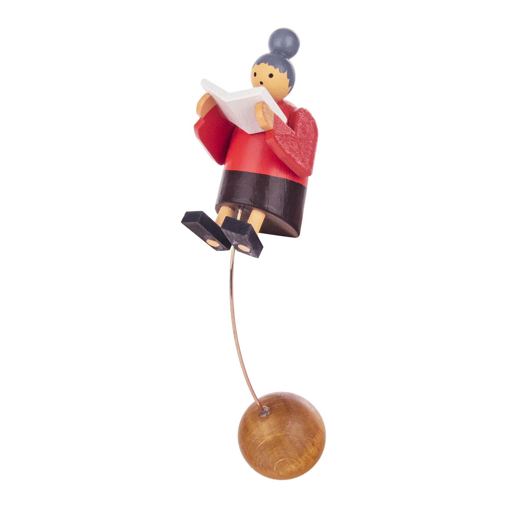 Wooden figure of a grandma with a bun, wearing a red dress, reading a book while rocking on a thin metal rod attached to a wooden base. im Dregeno Online Shop günstig kaufen