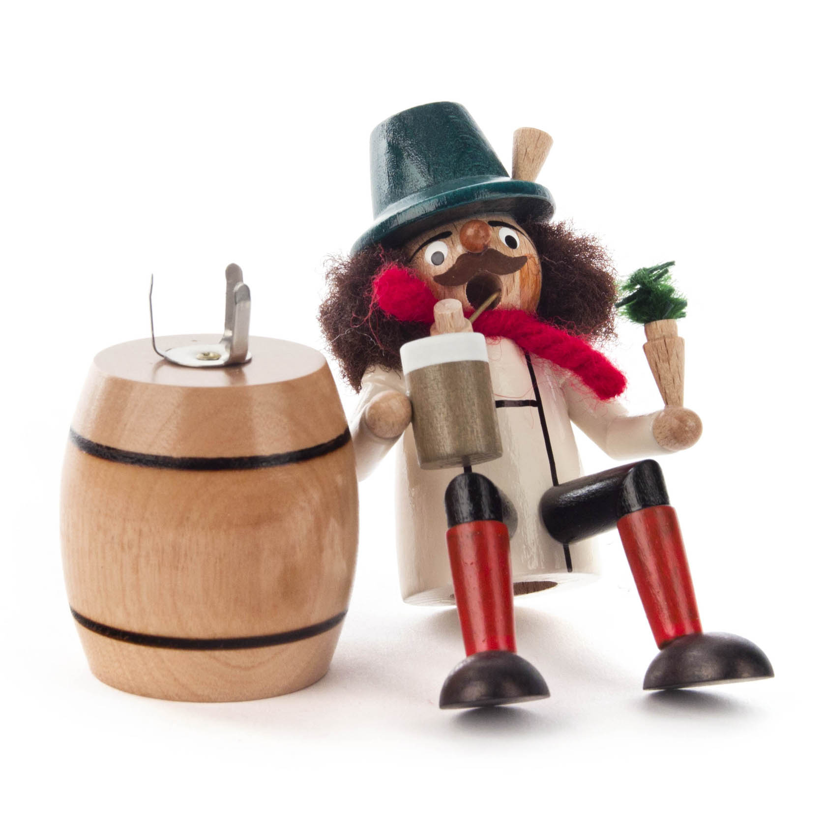 A small wooden figurine of a Bavarian man with a green hat and a red scarf, holding a mug and sitting beside a wooden barrel.