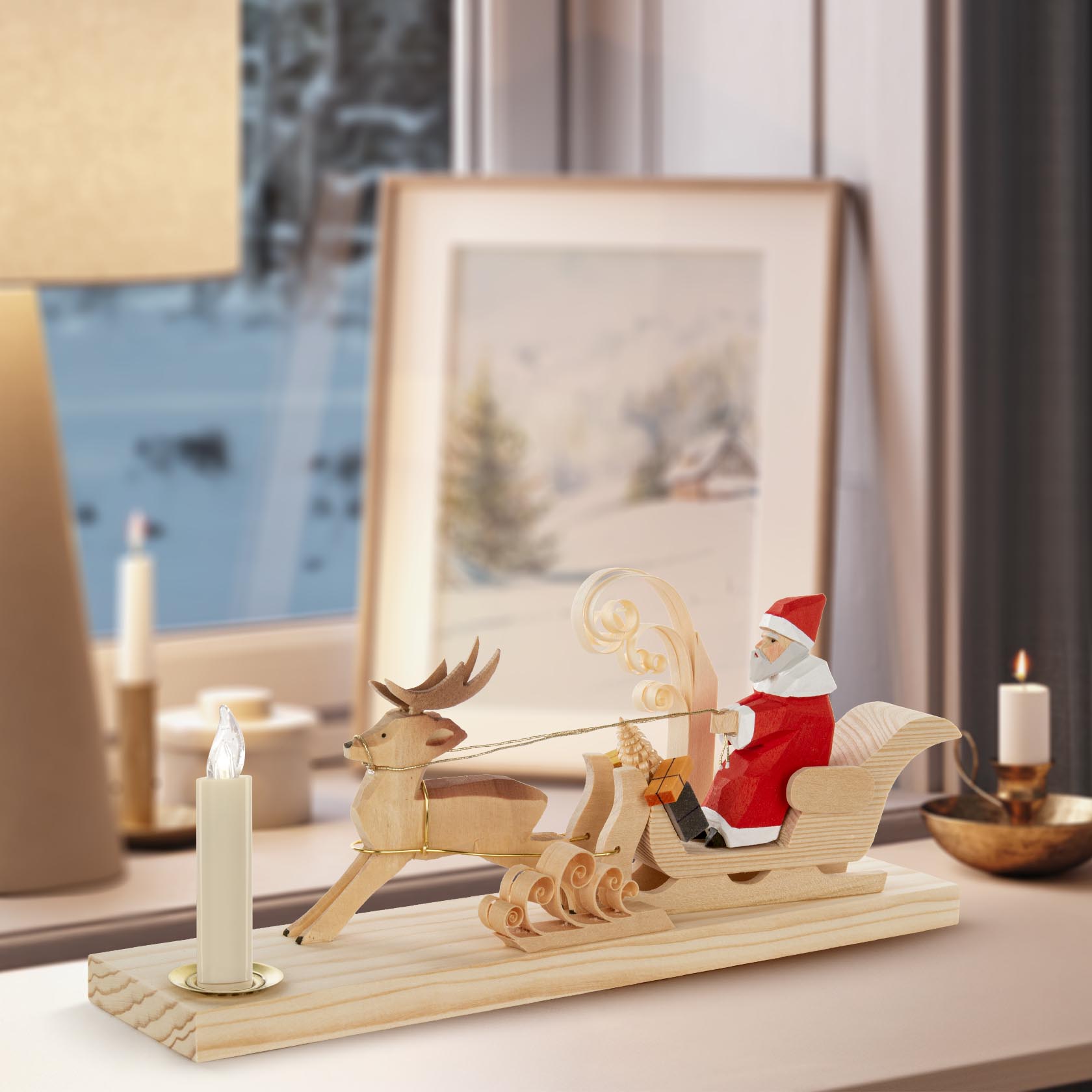 A wooden carved Santa in a sleigh pulled by a reindeer, designed to hold a 14mm diameter candle.