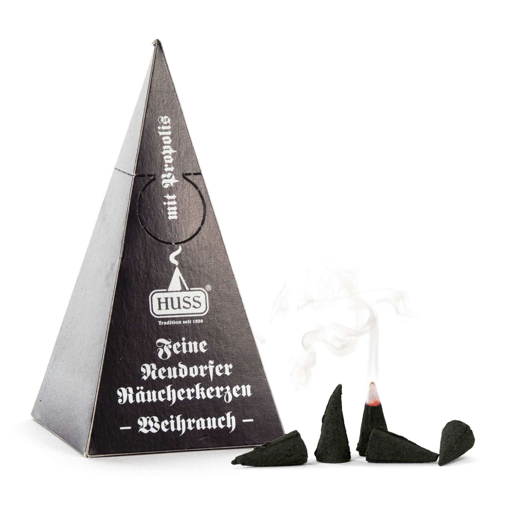 A pyramid-shaped black box labeled 'HUSS Neudorfer Räucherkerzen Weihrauch' with three small incense cones, one of which is lit and emitting smoke.