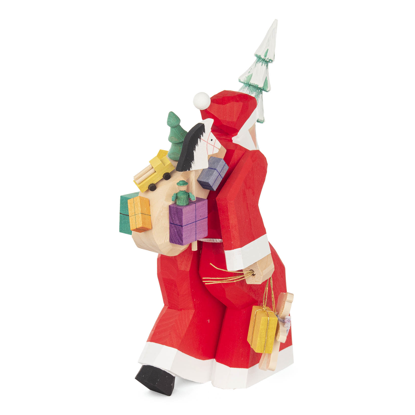 A carved wooden figure of Santa Claus carrying multiple colorful gifts in his sack and a small Christmas tree on his back.