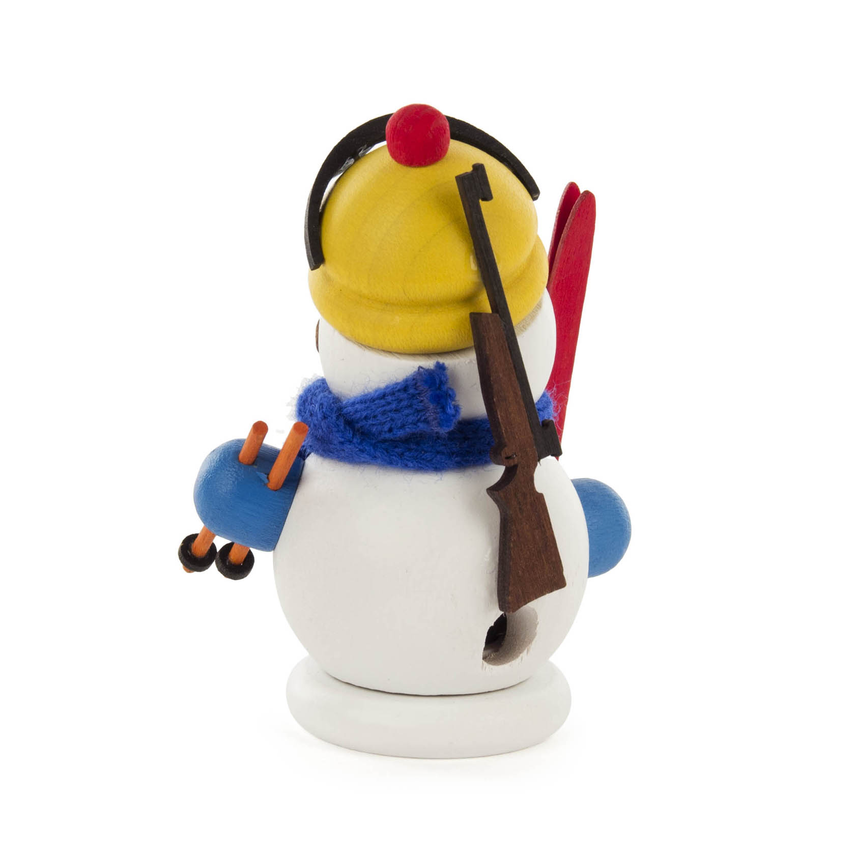 Small snowman figurine dressed as a biathlete with a yellow hat, blue scarf, skis, and a rifle slung on its back.