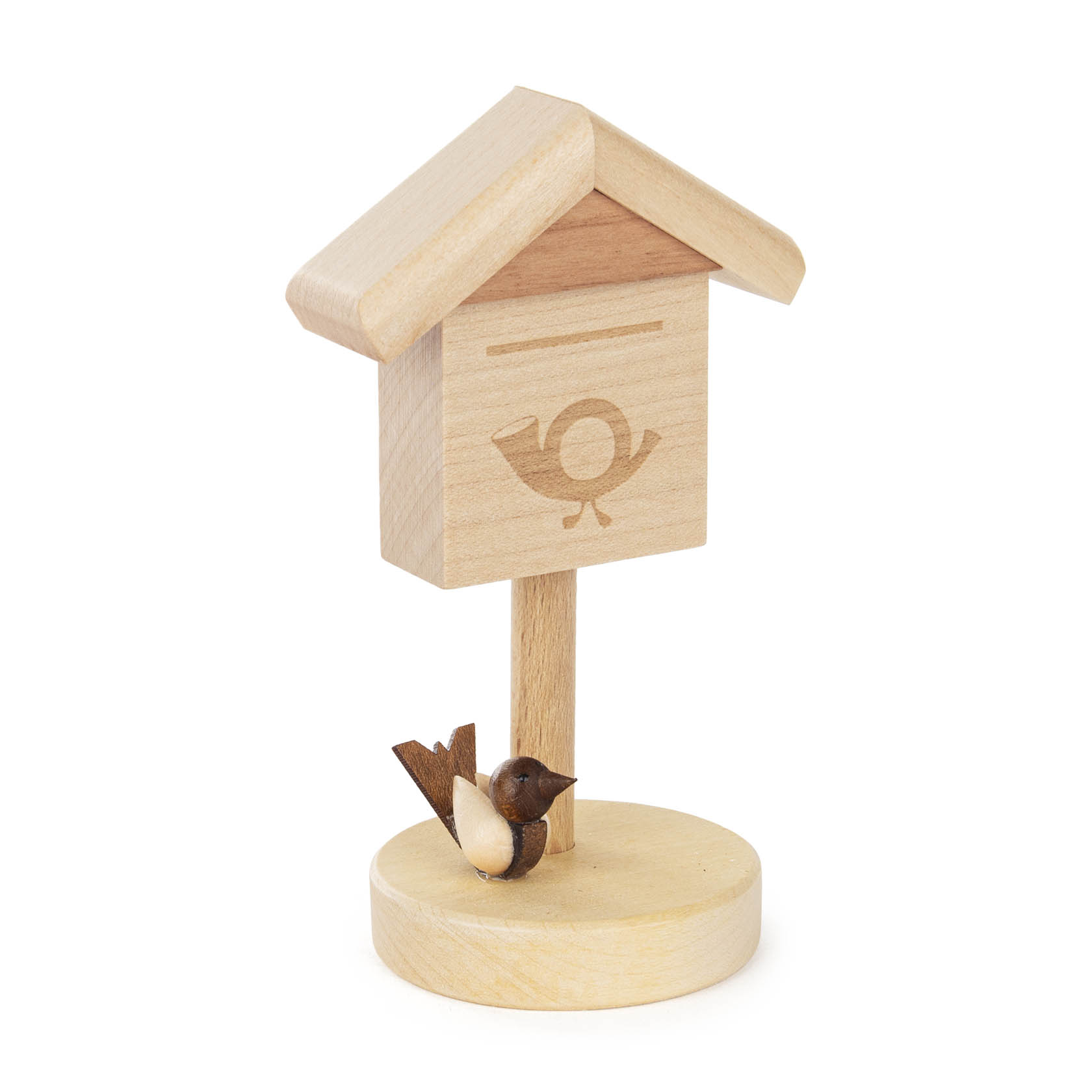 A small, wooden mailbox on a stand with a carved out bird emblem and a small wooden bird perched at the base.
