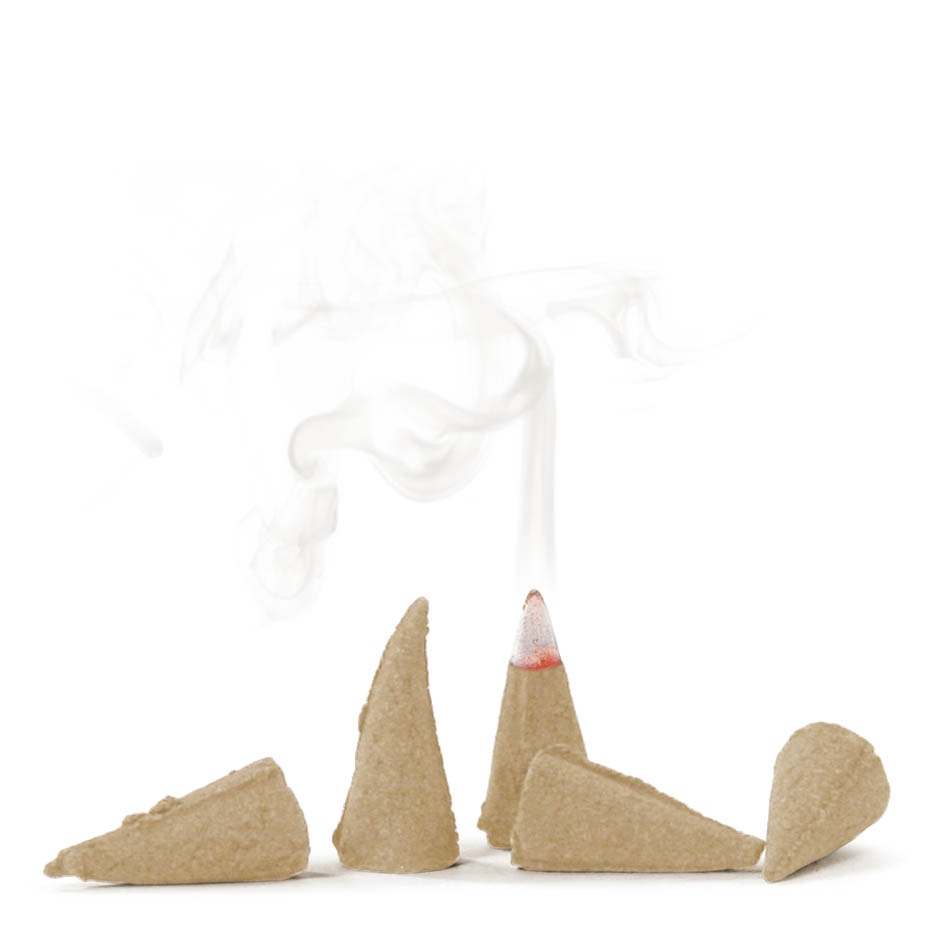 Five cone-shaped incense pieces, one burning, releasing smoke, resembling a vanilla crescent cookie.