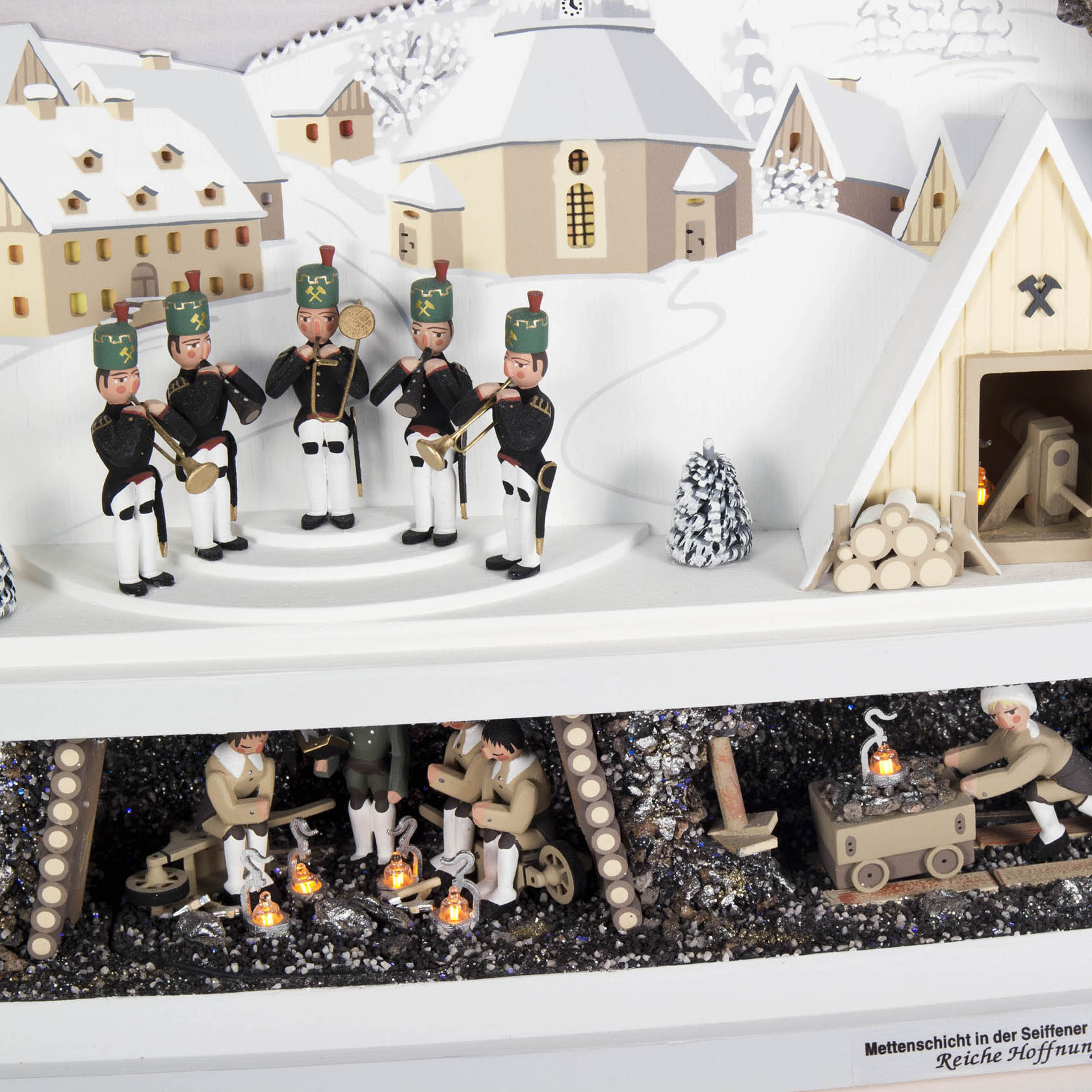 Electric illuminated Schwibbogen featuring the Seiffen village, miner's chapel, and mine with miniature figures and winter scenery.