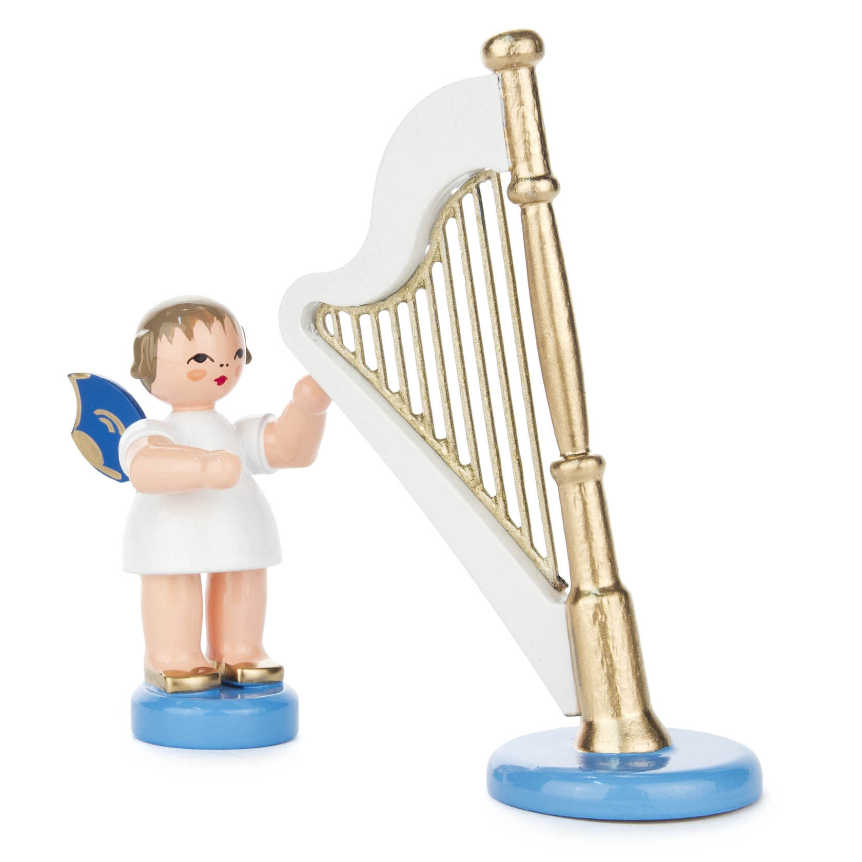 A small angel figurine with blue wings, wearing a white dress, stands beside a golden harp with a white frame.