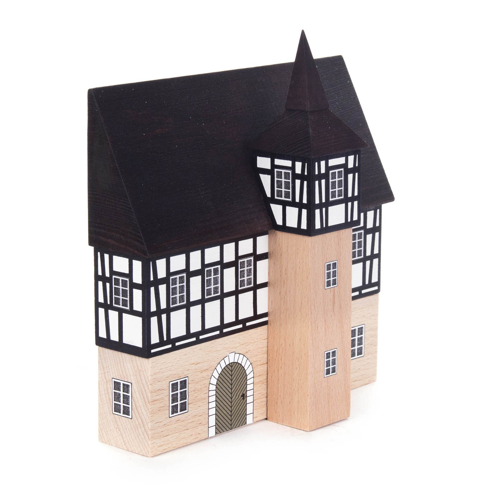 A miniature model of a half-timbered town hall with a pointed roof tower and black and white facade.