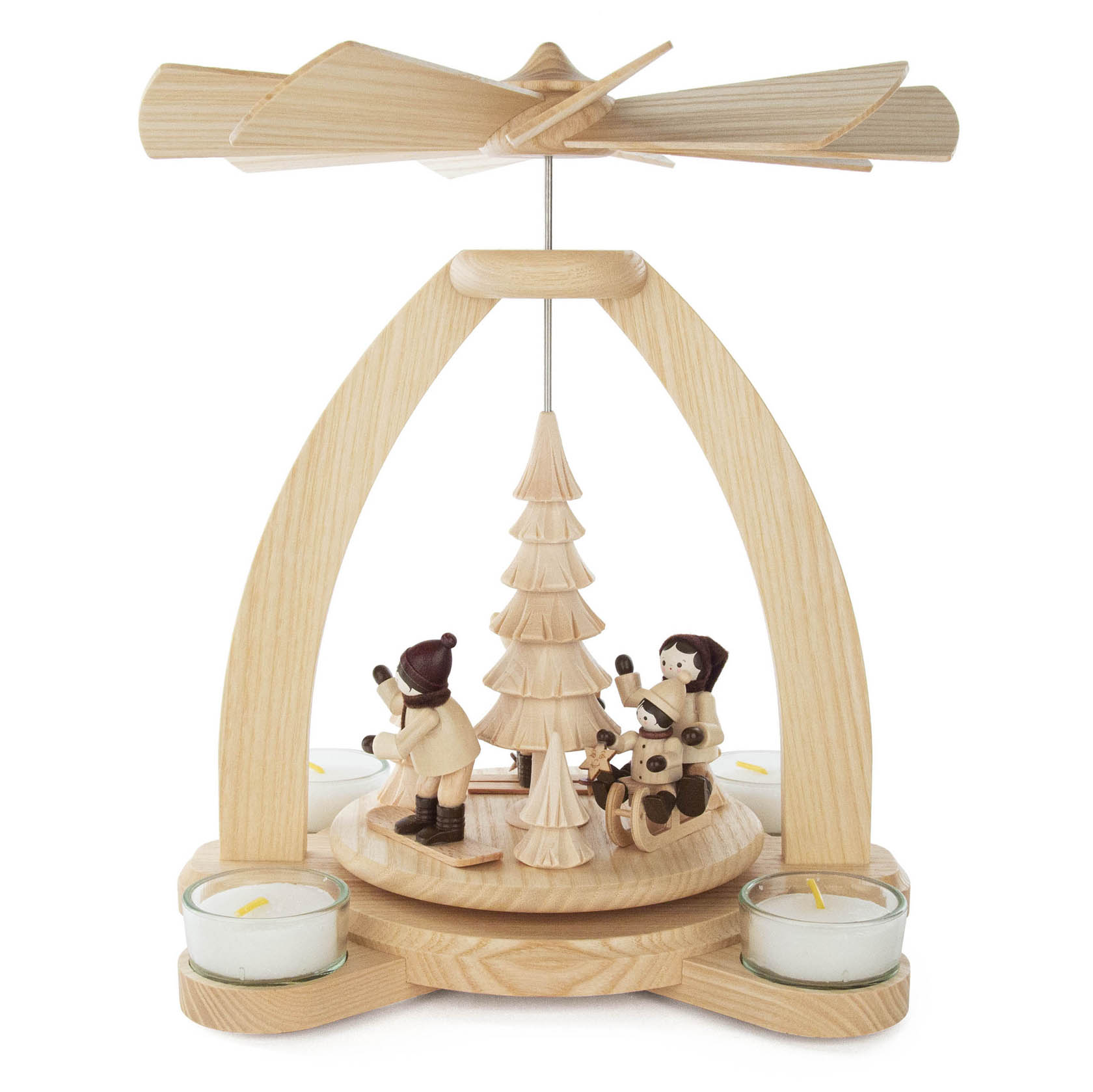 Wooden pyramid with a windmill on top, featuring figurines engaged in winter sports around a candle-lit platform.