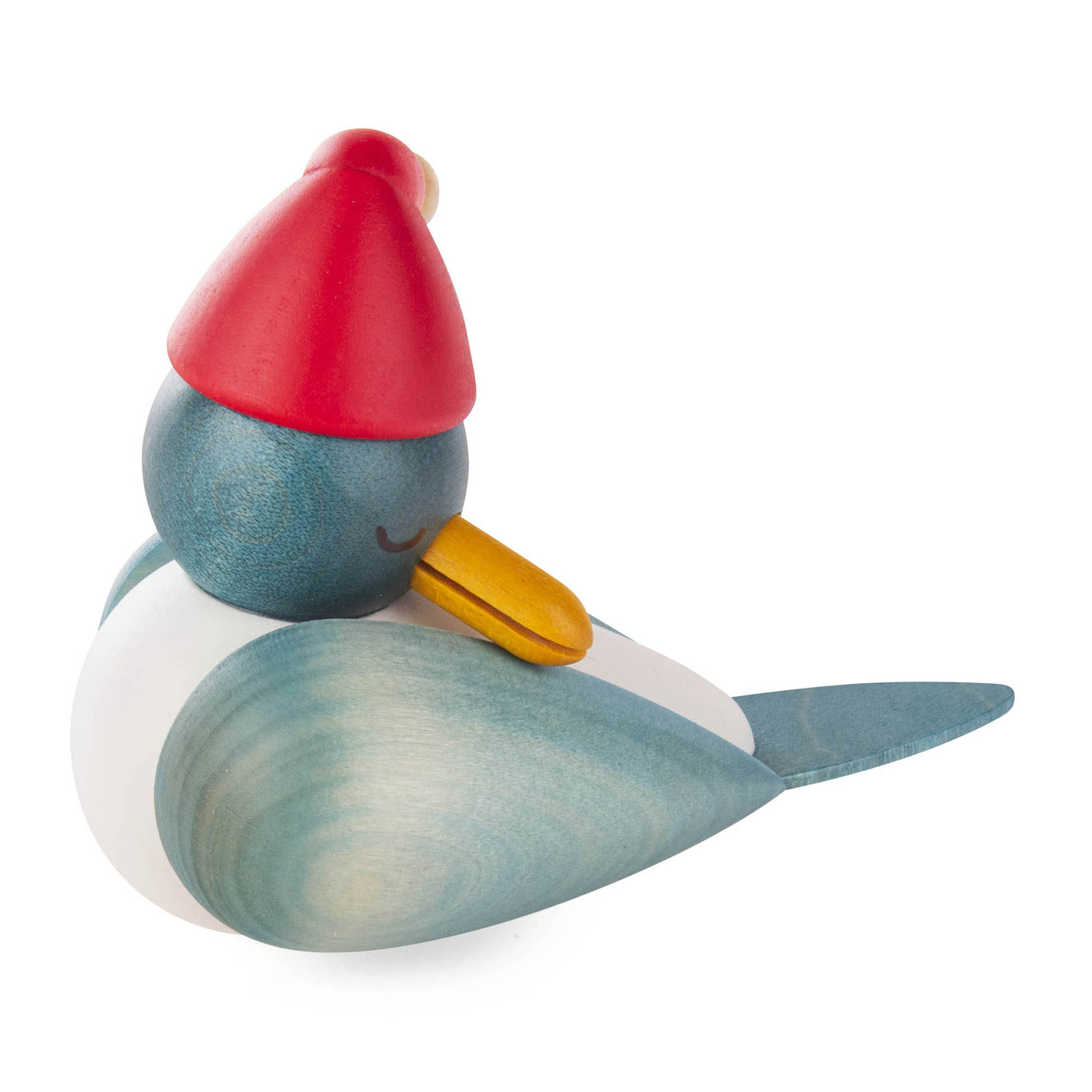 A wooden bird figurine with a red Santa hat, closed eyes, and a yellow beak, resembling a seagull. The body has shaded blue and white colors.