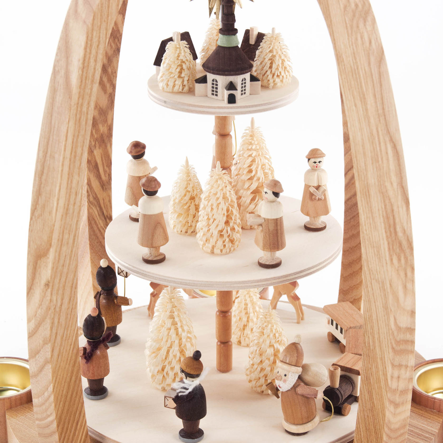 Three-tiered wooden Christmas pyramid with candle holders, featuring handcrafted figures like carolers, children, Christmas trees, and Santa.