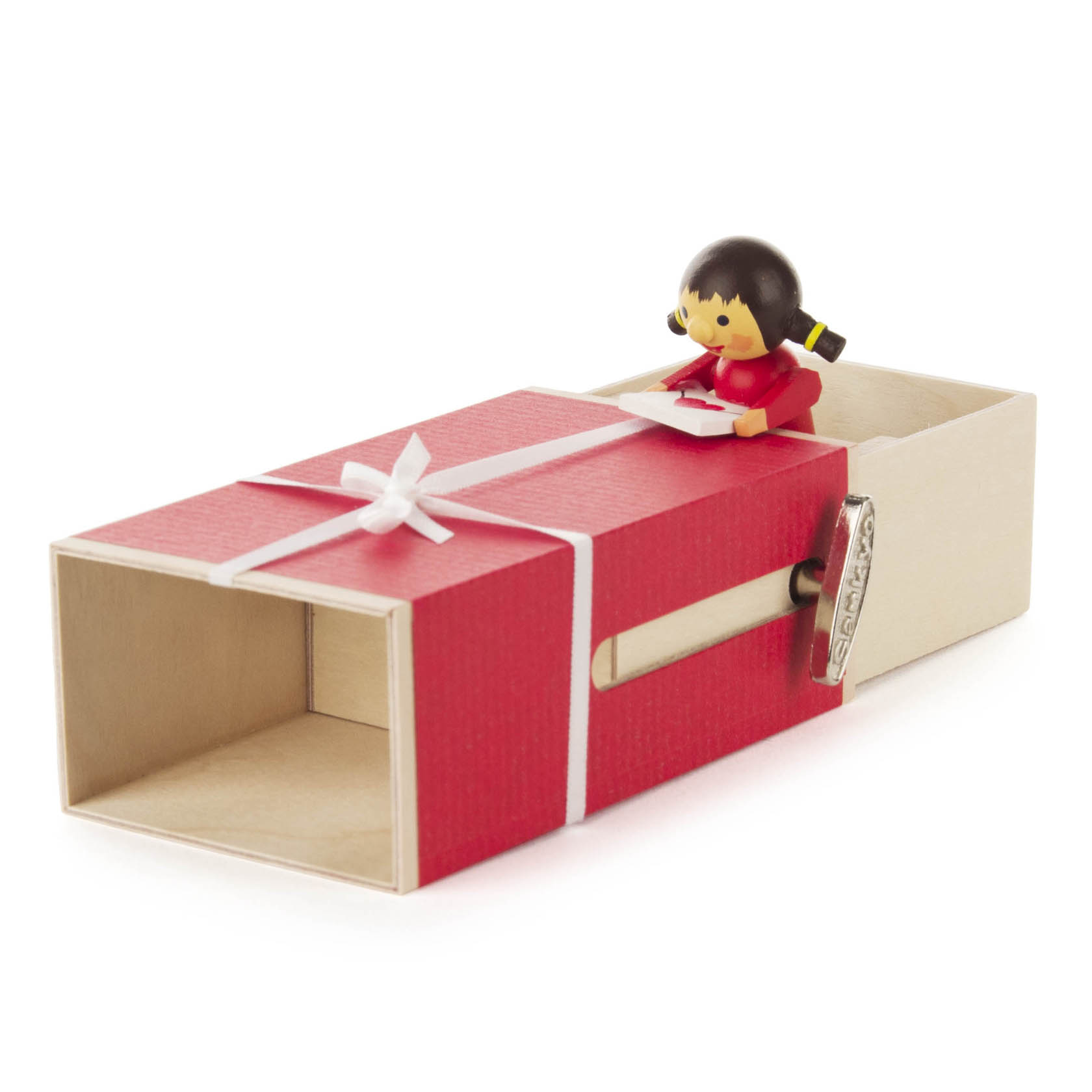 Spieluhr in Form einer Schiebebox mit rotem Geschenkdesign. Ein kleines Mädchen im roten Kleid hält einen Brief und sitzt oben auf der Box.