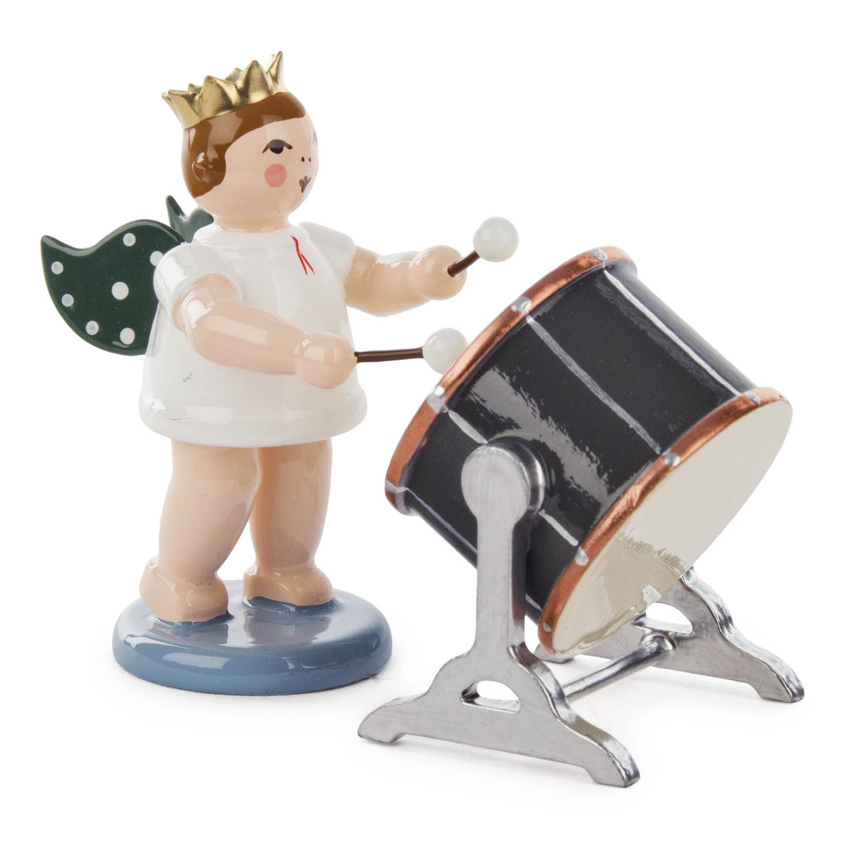 A wooden angel figurine wearing a crown, playing a large orchestral drum with mallets. The angel has green wings with white polka dots.