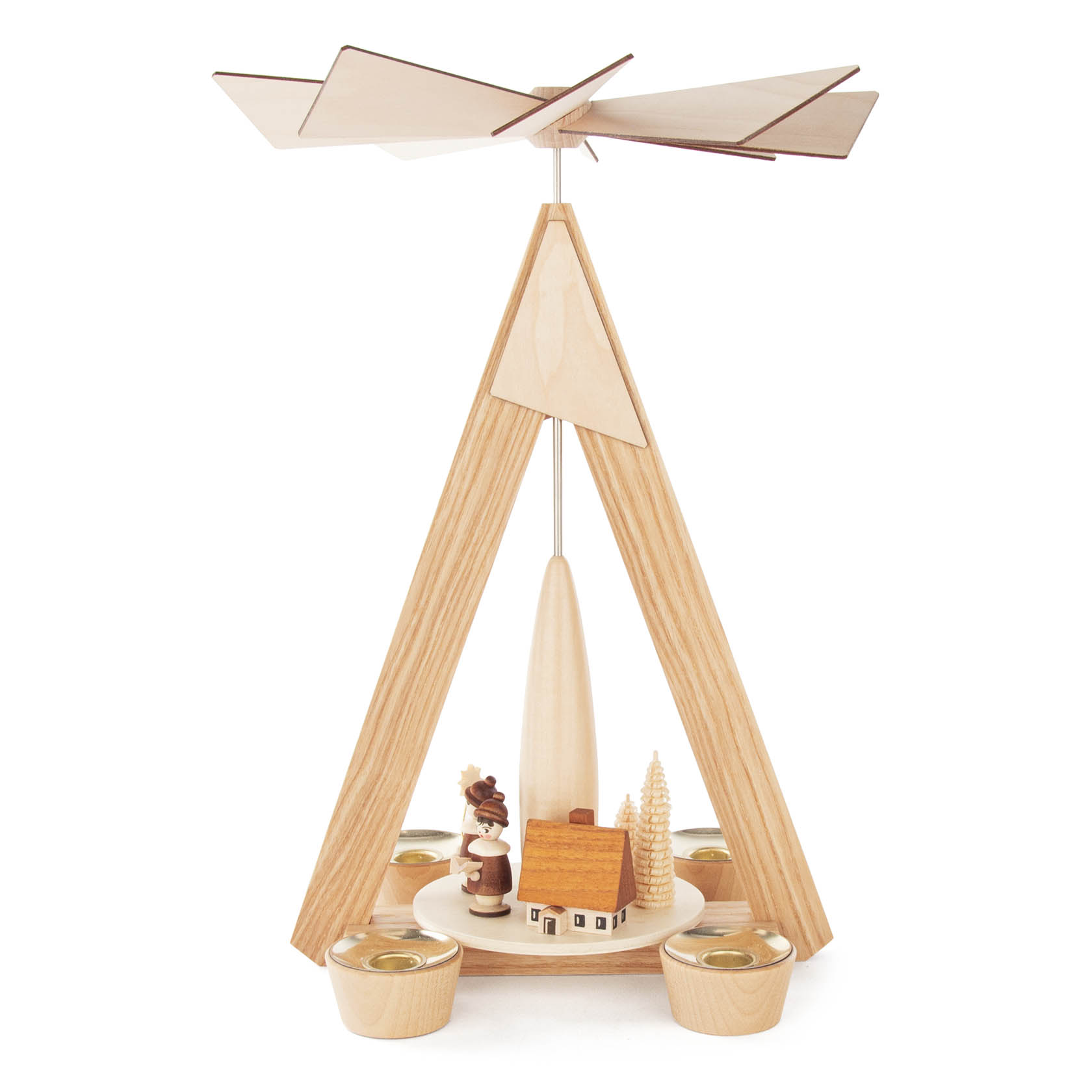 A wooden Christmas pyramid with a triangular frame, featuring a small house and trees, with four candle holders and a fan at the top.
