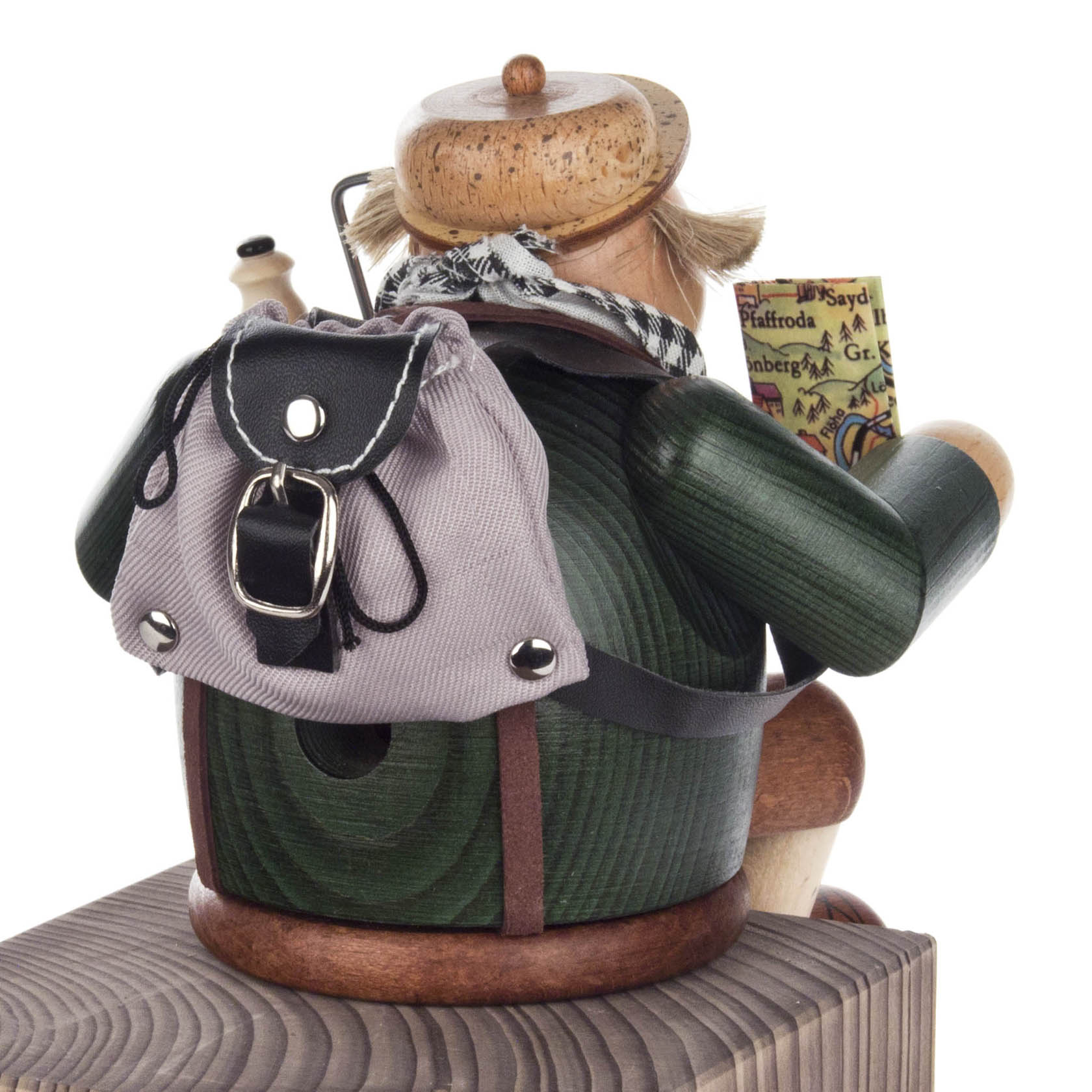 Wooden incense smoker figurine designed as a tourist sitting on the edge with a pipe, backpack, and map.