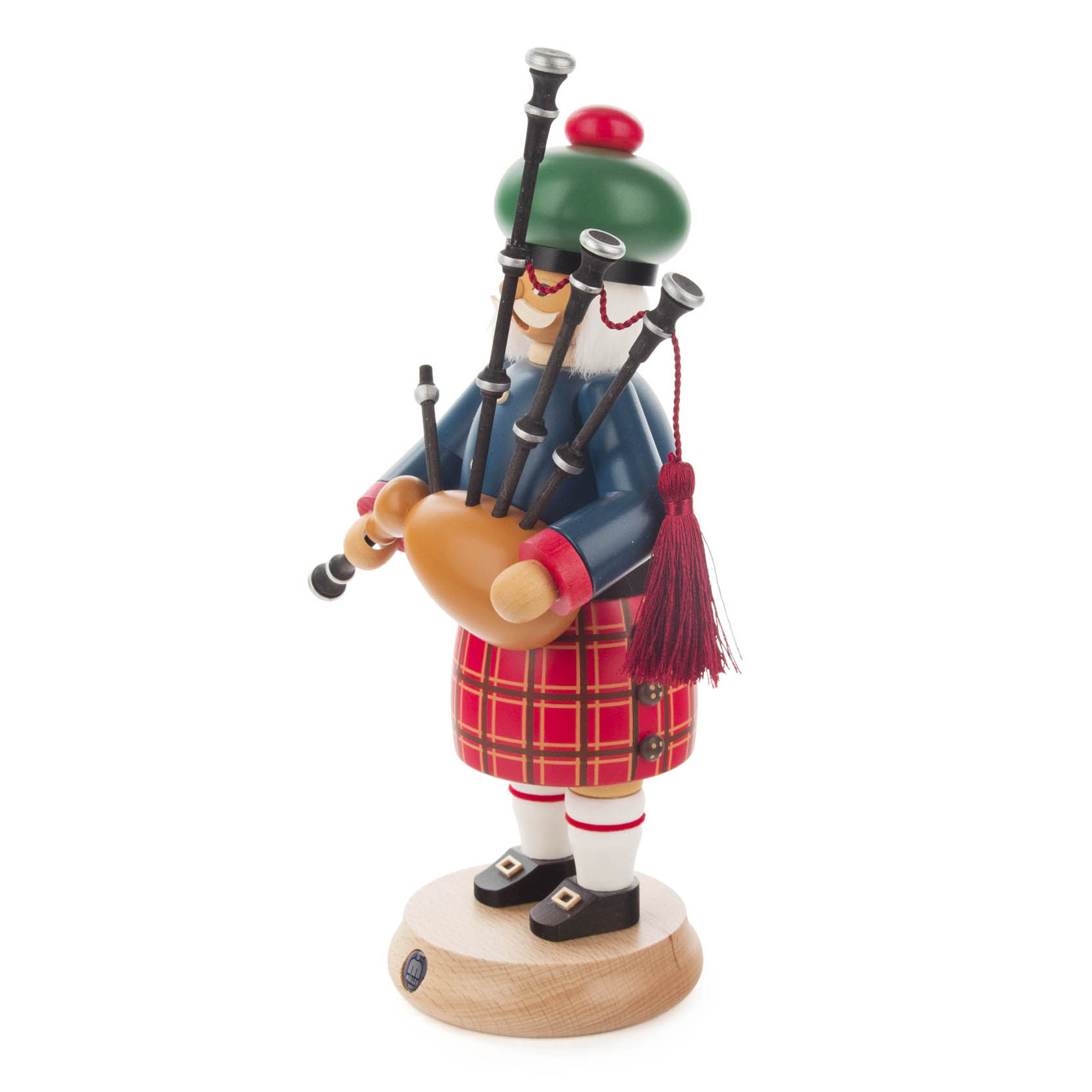 Wooden Scottish smoker figure wearing traditional attire and playing a bagpipe, with a checkered red kilt and green hat.