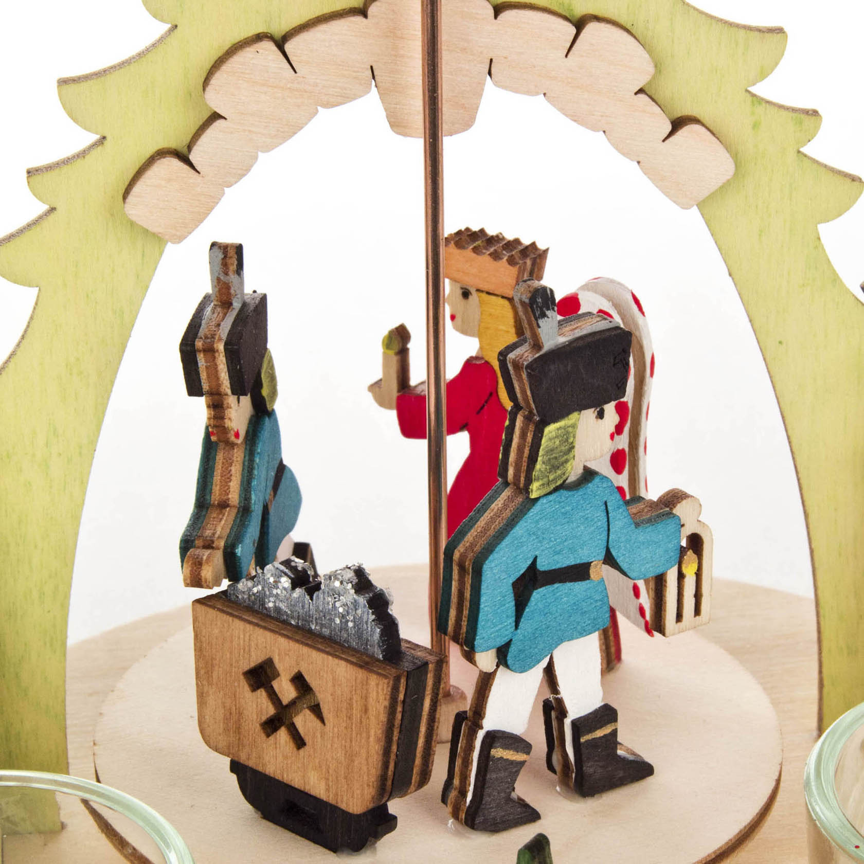 A handcrafted wooden Erzgebirge pyramid featuring small, colorful figures of a miner, a king, and a child with candy cane.