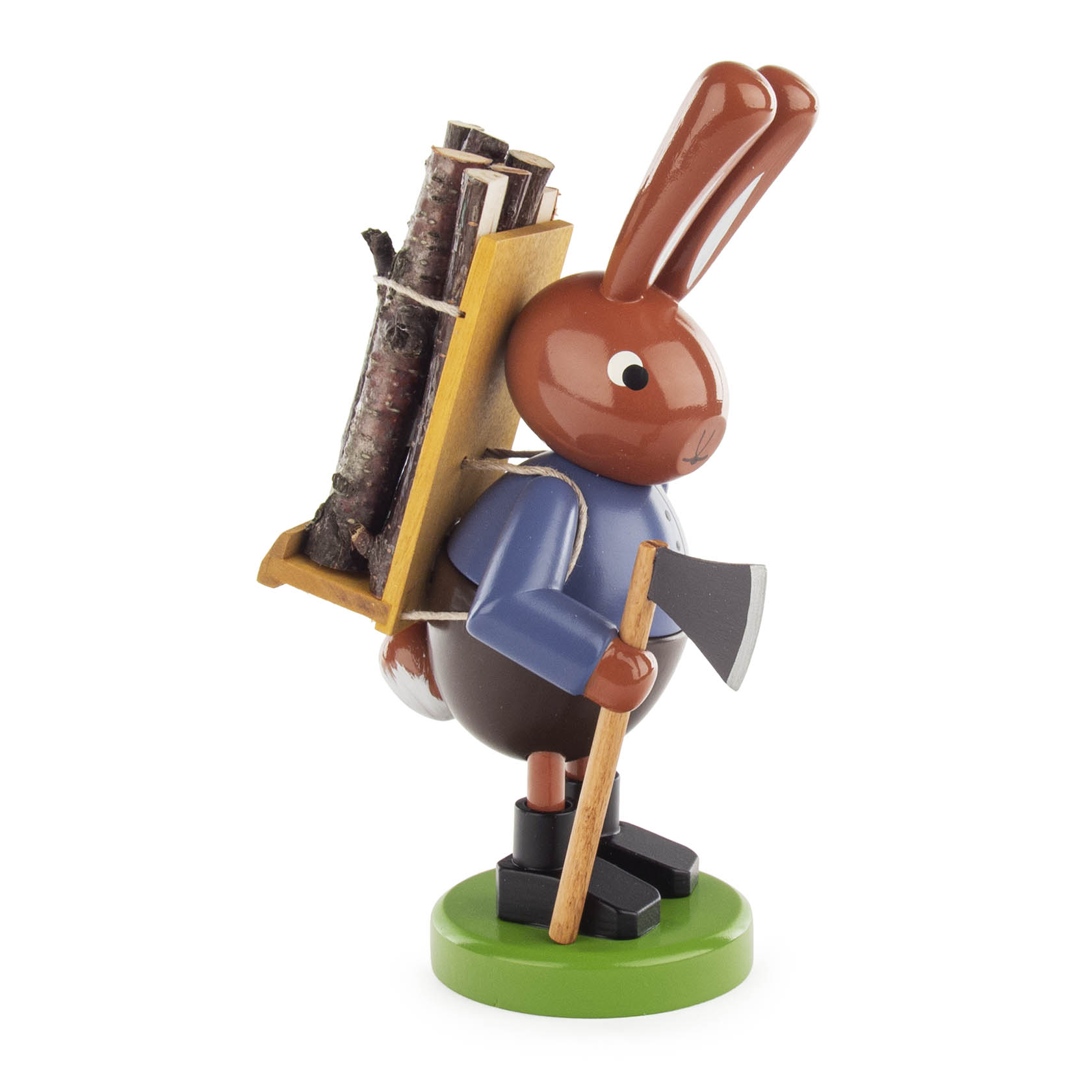 Wooden figurine of a rabbit carrying a wooden backpack filled with logs, holding an axe, standing on a green base.