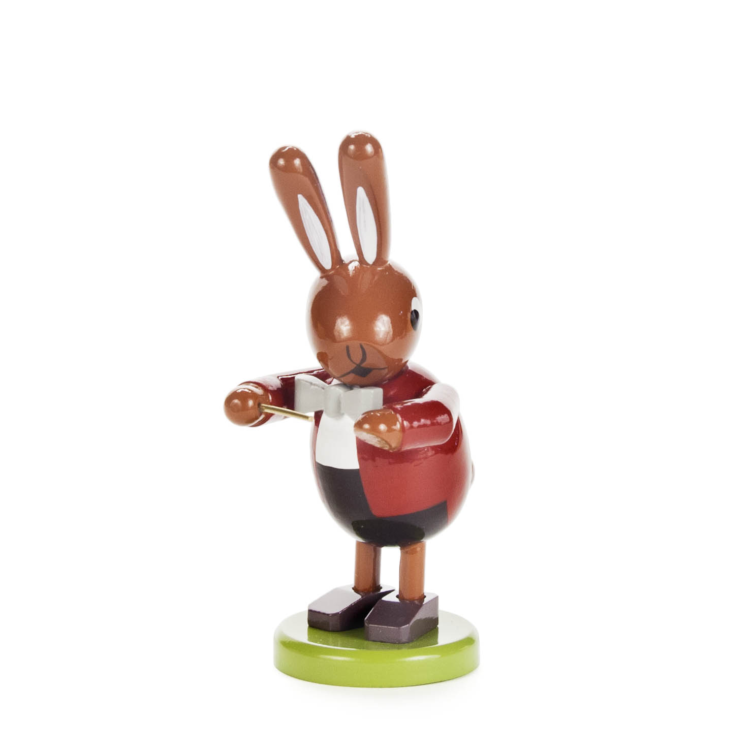 Small wooden figurine of a rabbit dressed as a conductor, holding a baton, wearing a red jacket and standing on a green base. im Dregeno Online Shop günstig kaufen