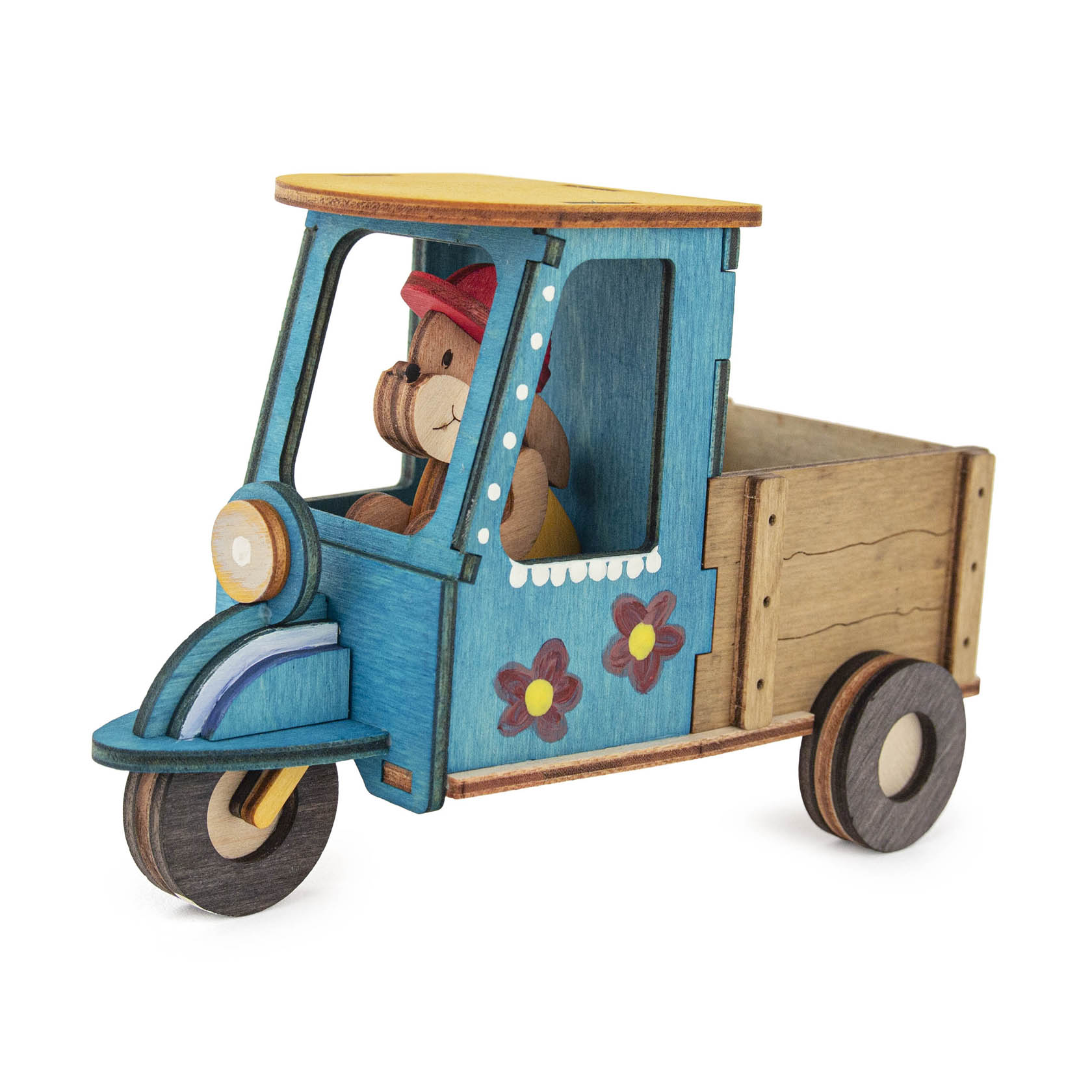 A handcrafted wooden Easter-themed tricycle with a bunny driver, featuring a yellow roof and floral decorations.