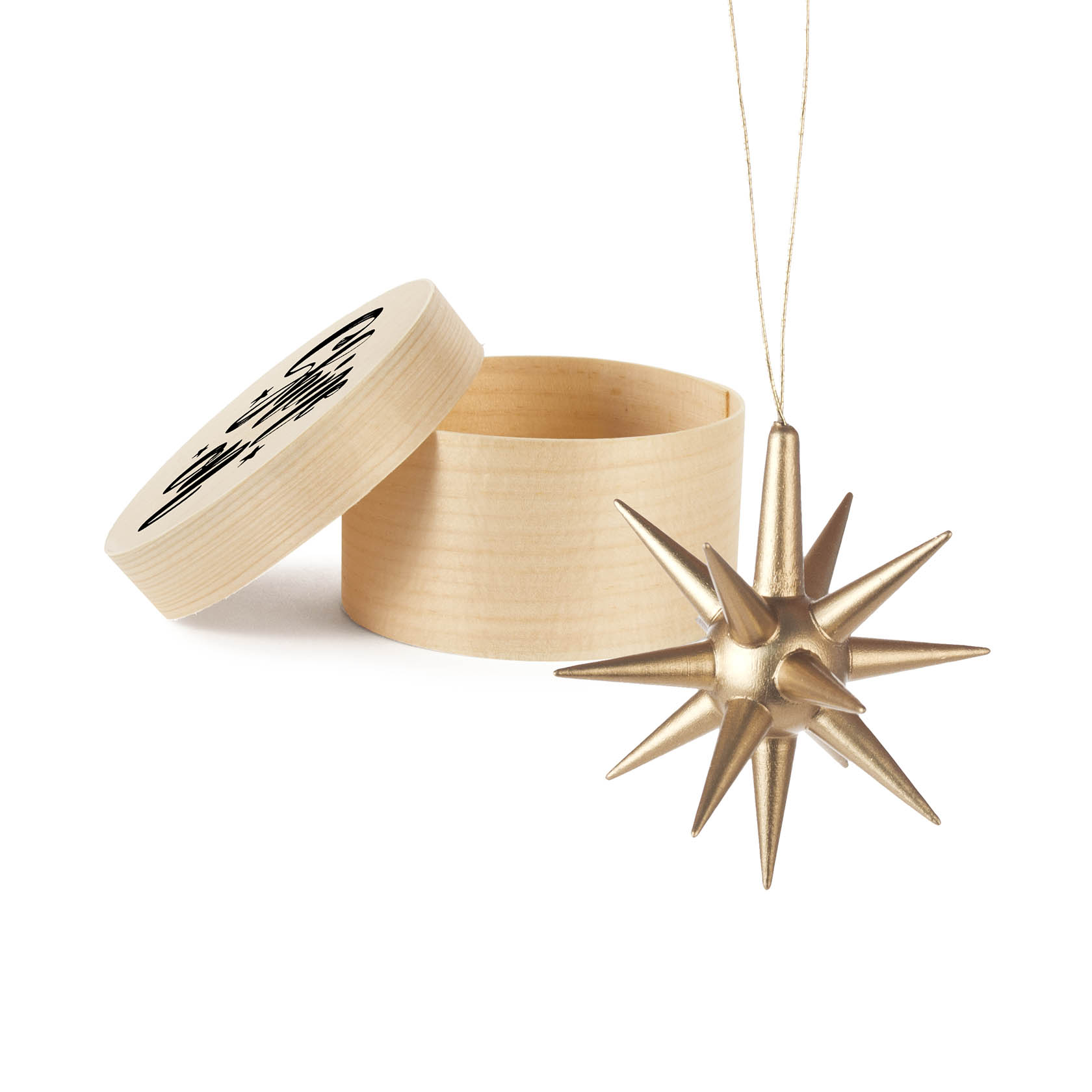 A golden star ornament with spikes, designed for hanging, next to an open round box with 'Shine on' printed on the lid.