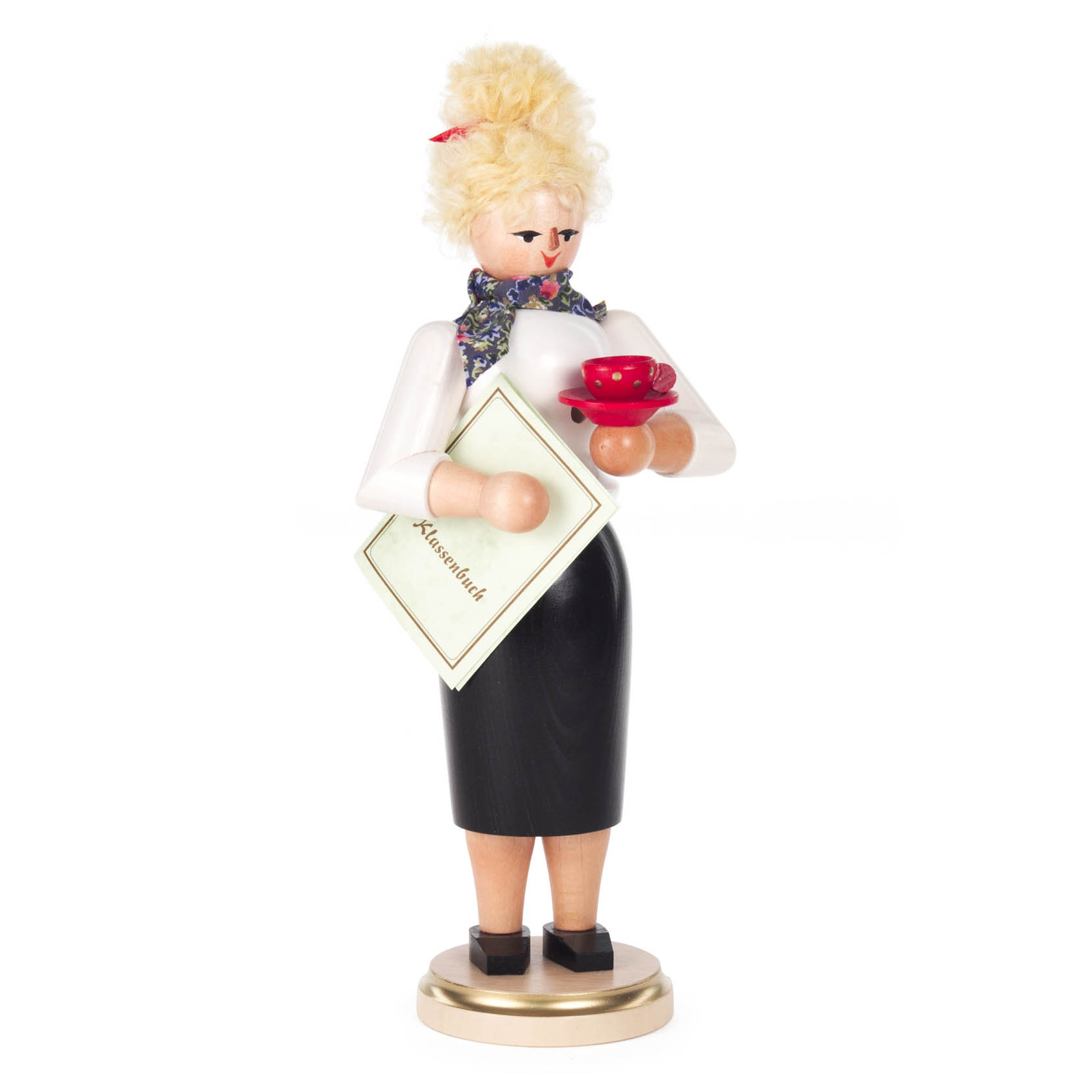Räucherfigur einer Lehrerin mit blonden Haaren, weißem Oberteil, schwarzem Rock und einem Schal. Sie hält ein rotes Teeset und ein Buch mit der Aufschrift 'Alte Schrift'. im Dregeno Online Shop günstig kaufen