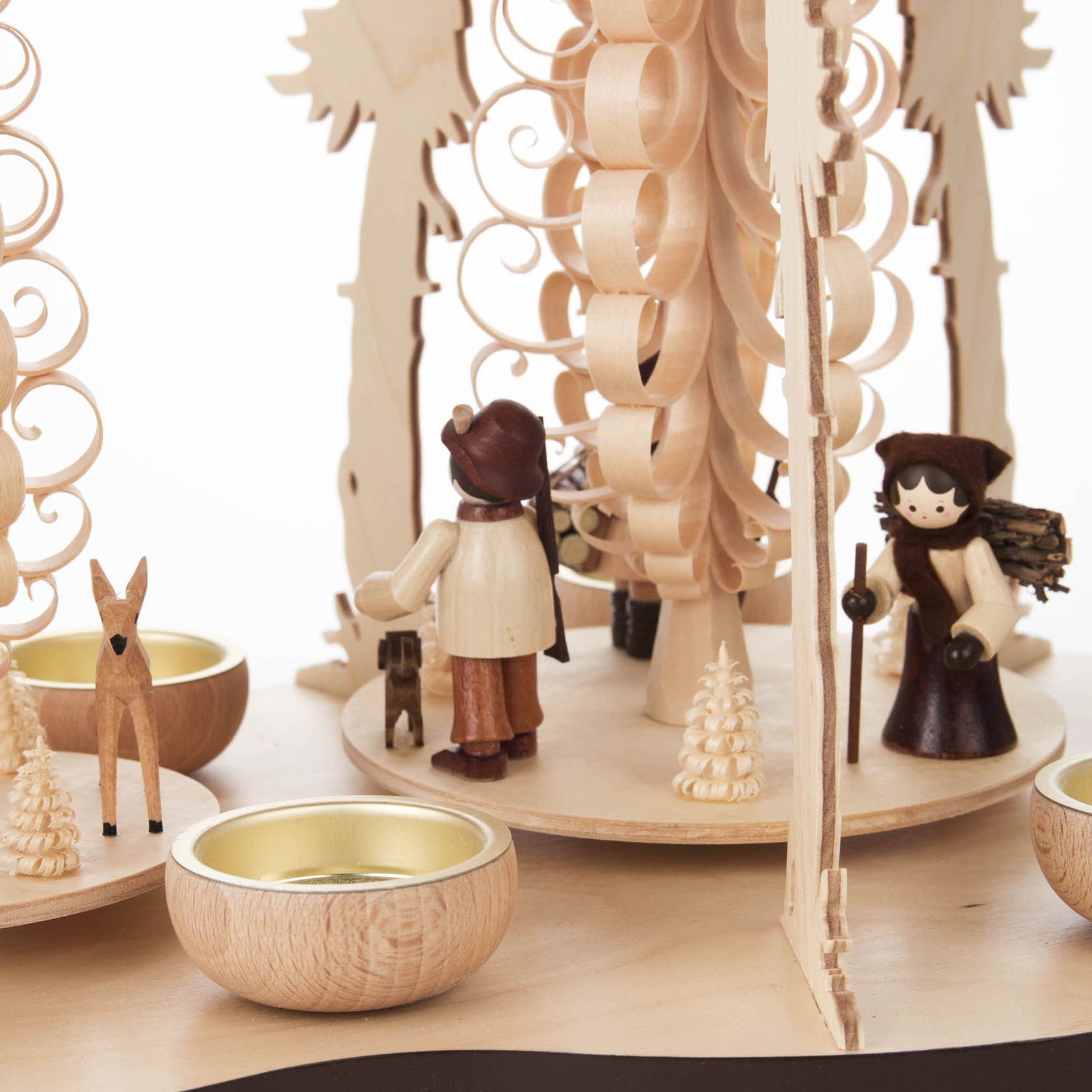 Wooden pyramid with carved forest people, deer, and tealight holders.