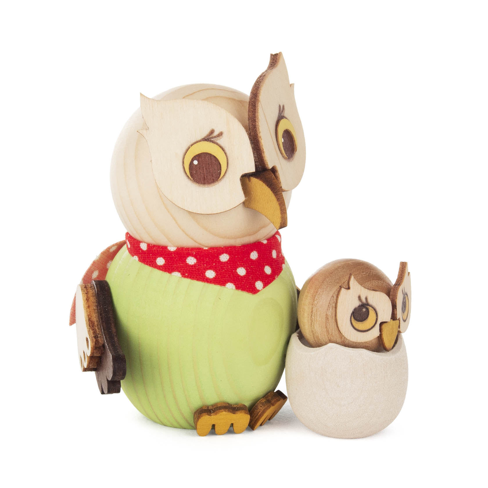 Wooden figurine of a mother owl wearing a green dress with a red polka dot scarf, standing beside a baby owl nestled in an eggshell.