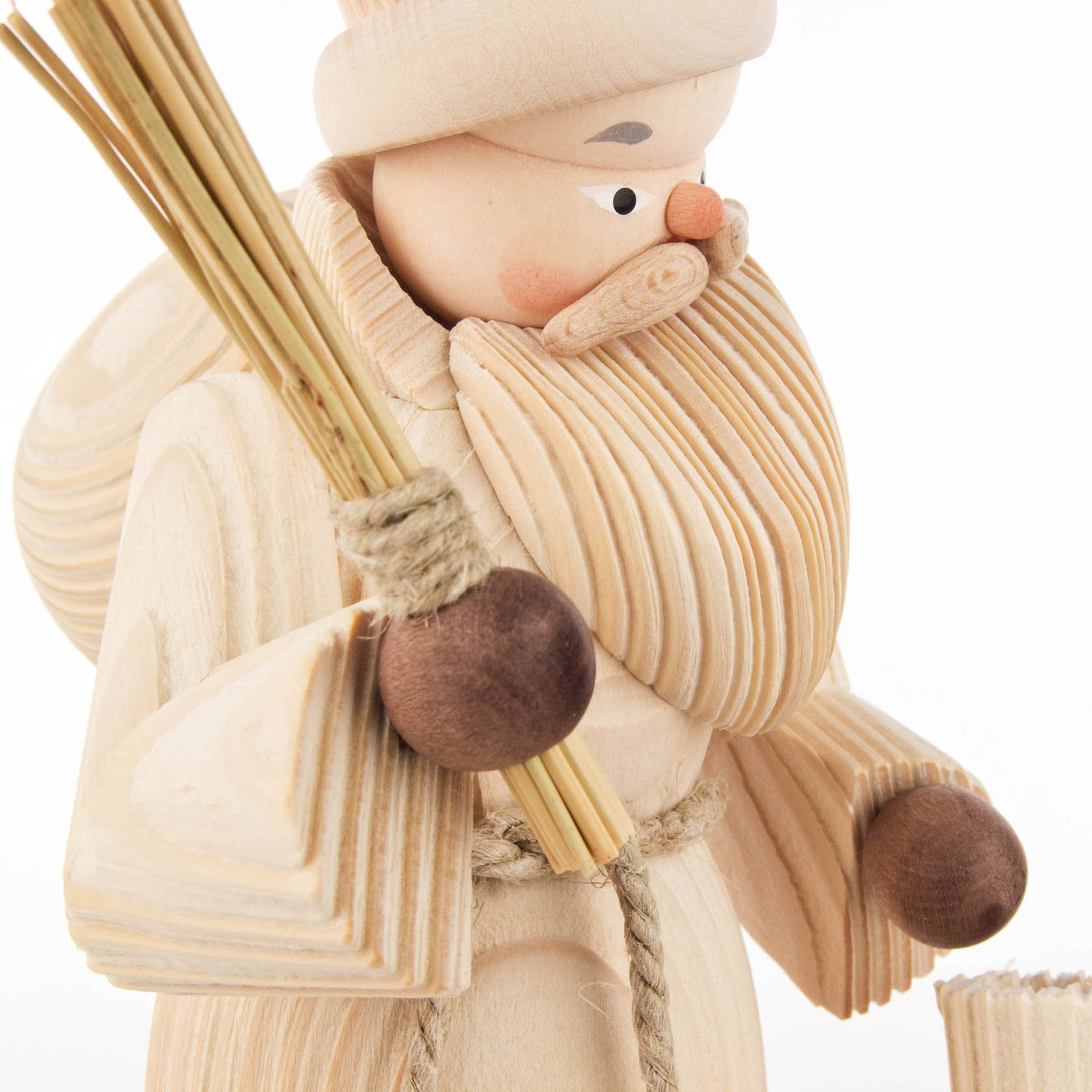 Wooden incense smoker in the shape of a natural-colored Santa Claus holding a sack and a bundle of sticks, detailed with carved textures.