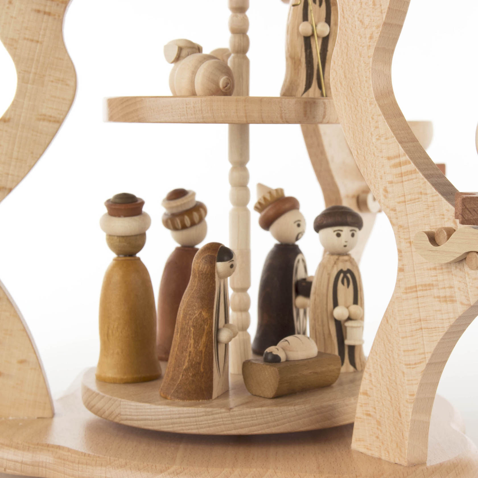 A two-tiered wooden Christmas pyramid featuring a nativity scene with wooden figures, including Mary, Joseph, and baby Jesus in a manger.