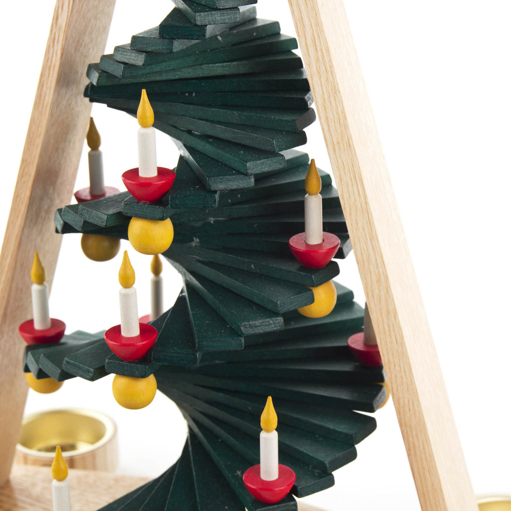 A wooden spiral pyramid with dark green tiers, each holding red and yellow candle holders, designed for tea lights.
