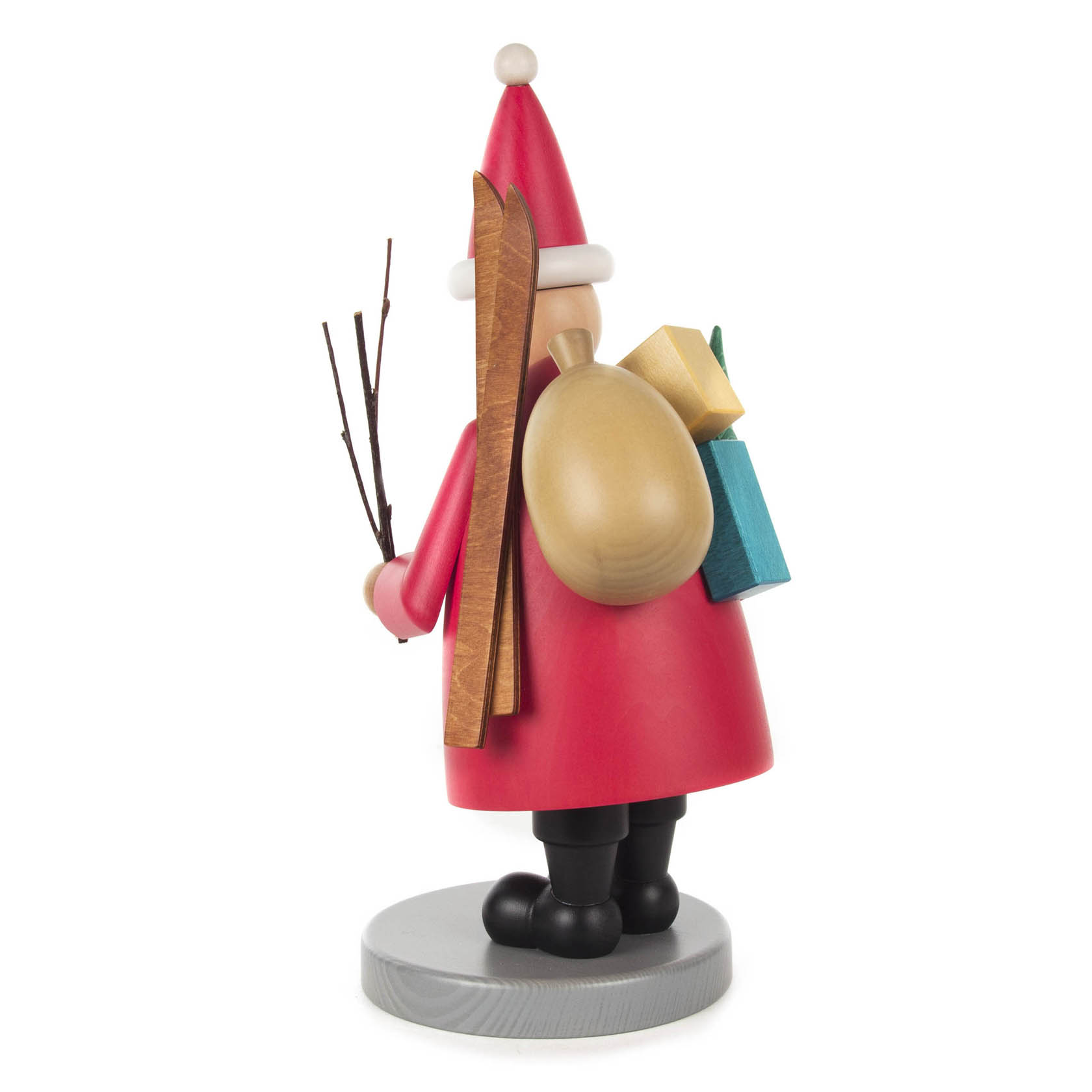 Traditional German incense smoker figure of Santa Claus holding skis, gifts, and twigs, standing on a round base.