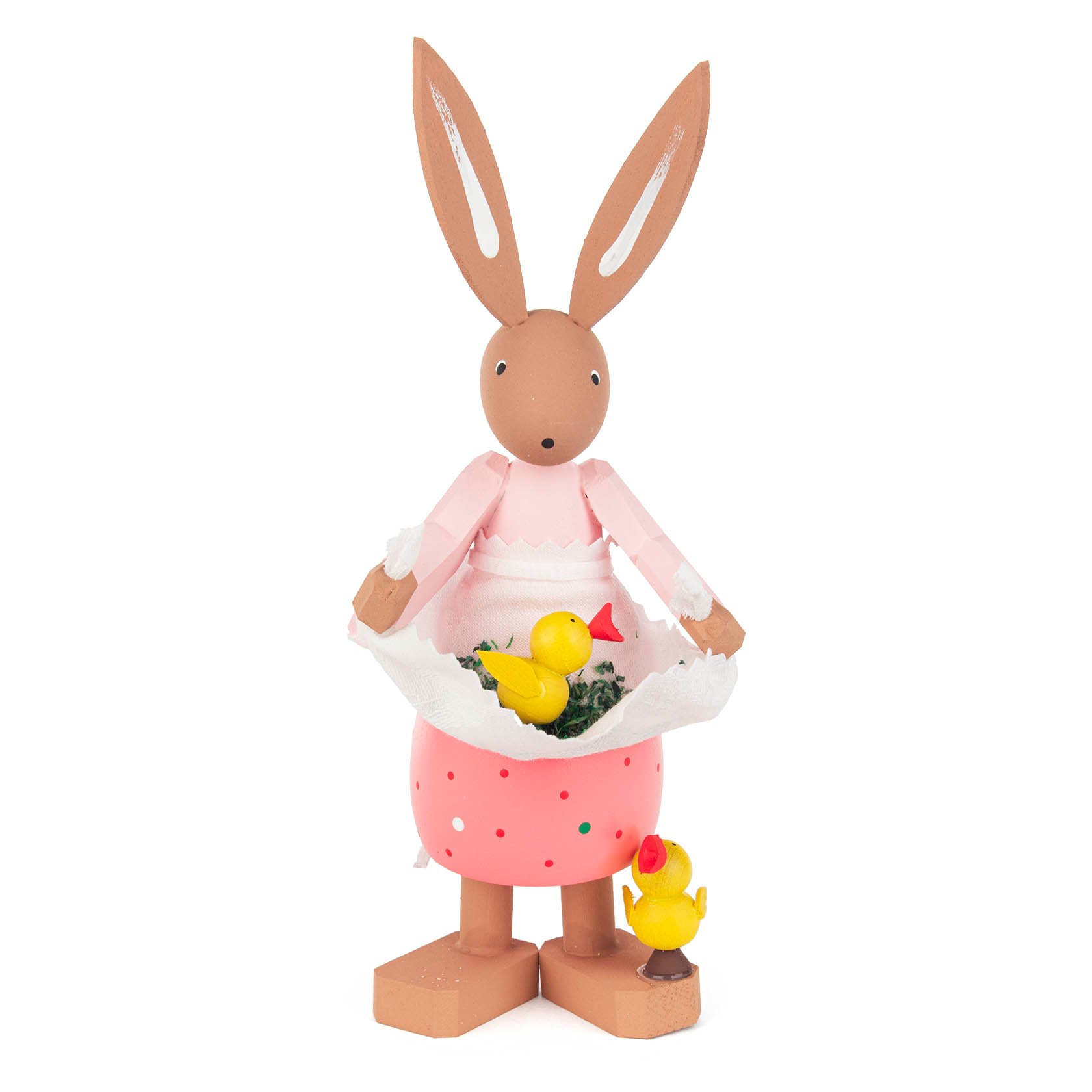 A wooden Easter bunny figurine named Hanni, wearing a pink dress and holding a white apron filled with small yellow chicks. im Dregeno Online Shop günstig kaufen