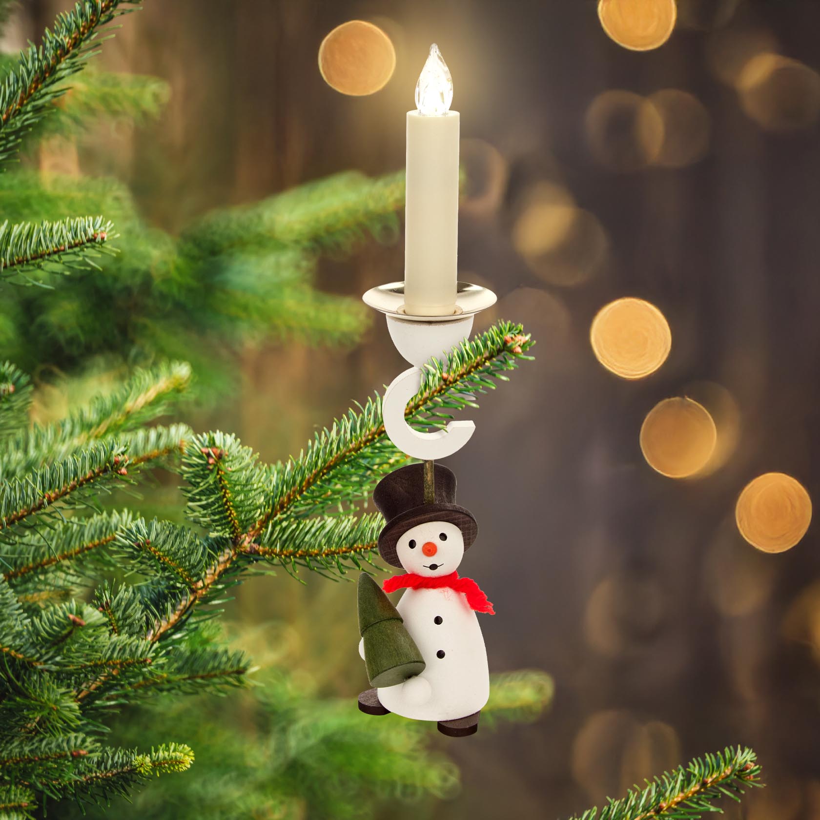 A snowman candle holder with a tree attachment hanging on a branch, designed for 14mm candles.