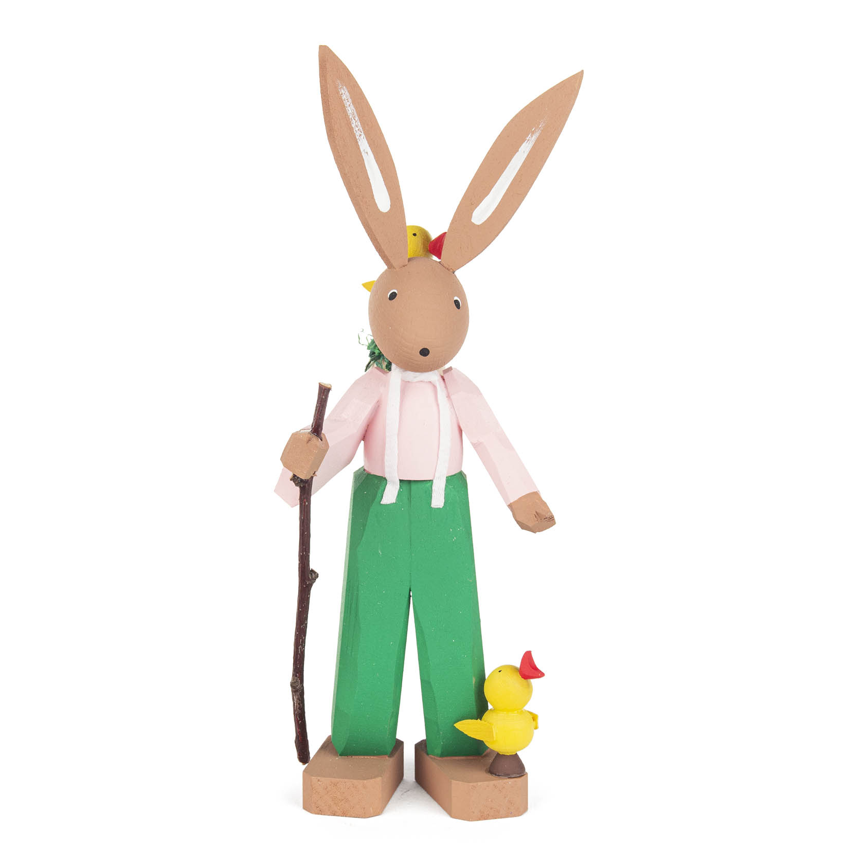 A wooden figurine of an Easter bunny named Hugo, with long ears and a small yellow chick on its shoulder. It holds a stick and wears green pants and a pink shirt. im Dregeno Online Shop günstig kaufen