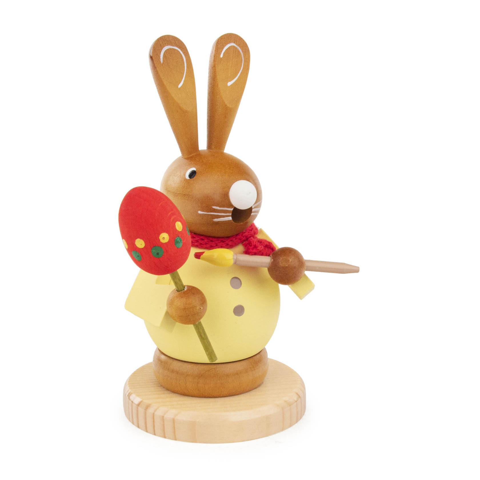 A wooden incense smoker figurine of a rabbit named 'Eiermaler', holding a red Easter egg and a paintbrush, dressed in a yellow shirt.