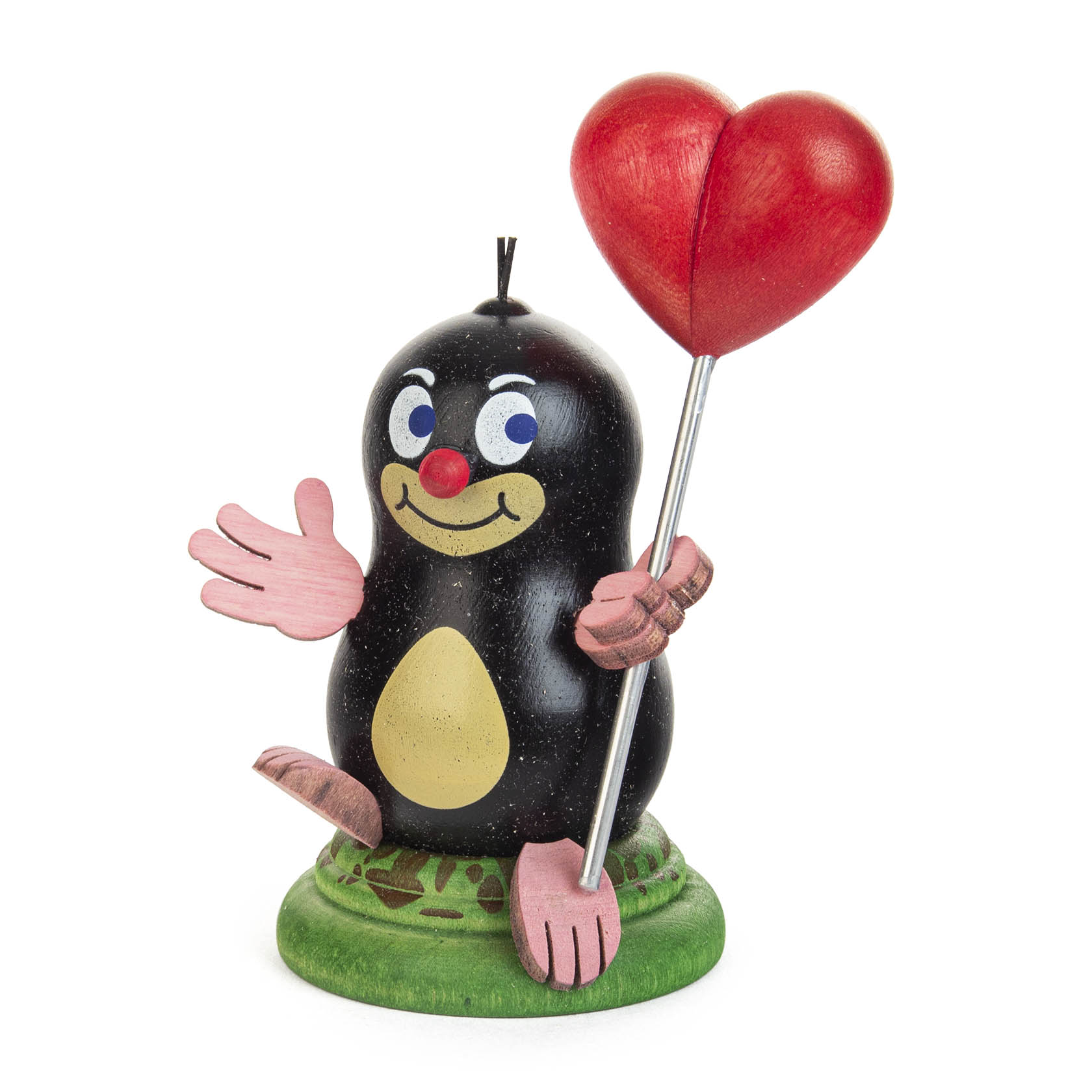 Eine bunte Figur eines Maulwurfs mit rosa Händen und Füßen, der lachend einen roten Herzballon hält, auf einem grünen Sockel sitzend. im Dregeno Online Shop günstig kaufen