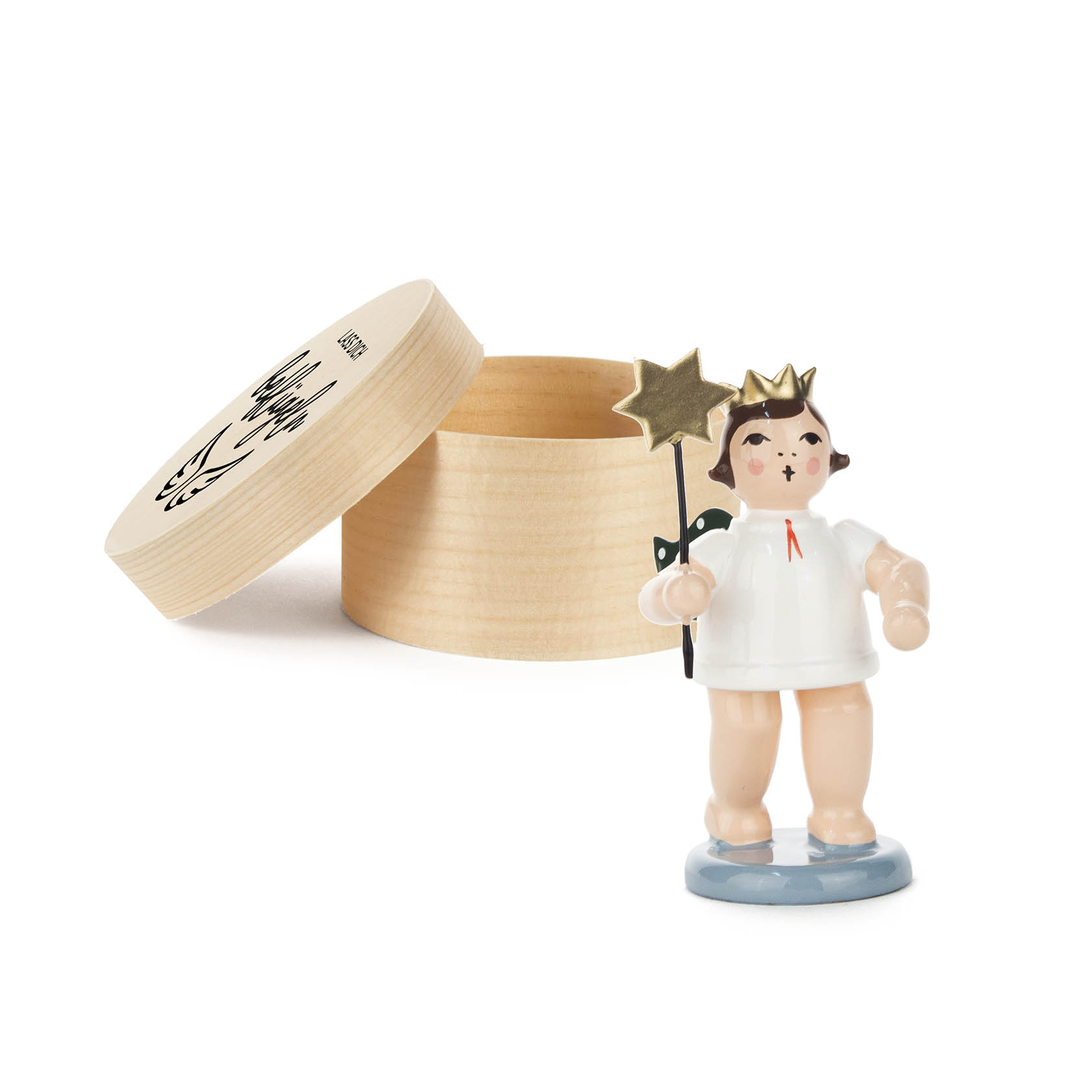 A small angel figurine with a gold crown and holding a star wand, standing on a blue base, next to an open round wooden box.